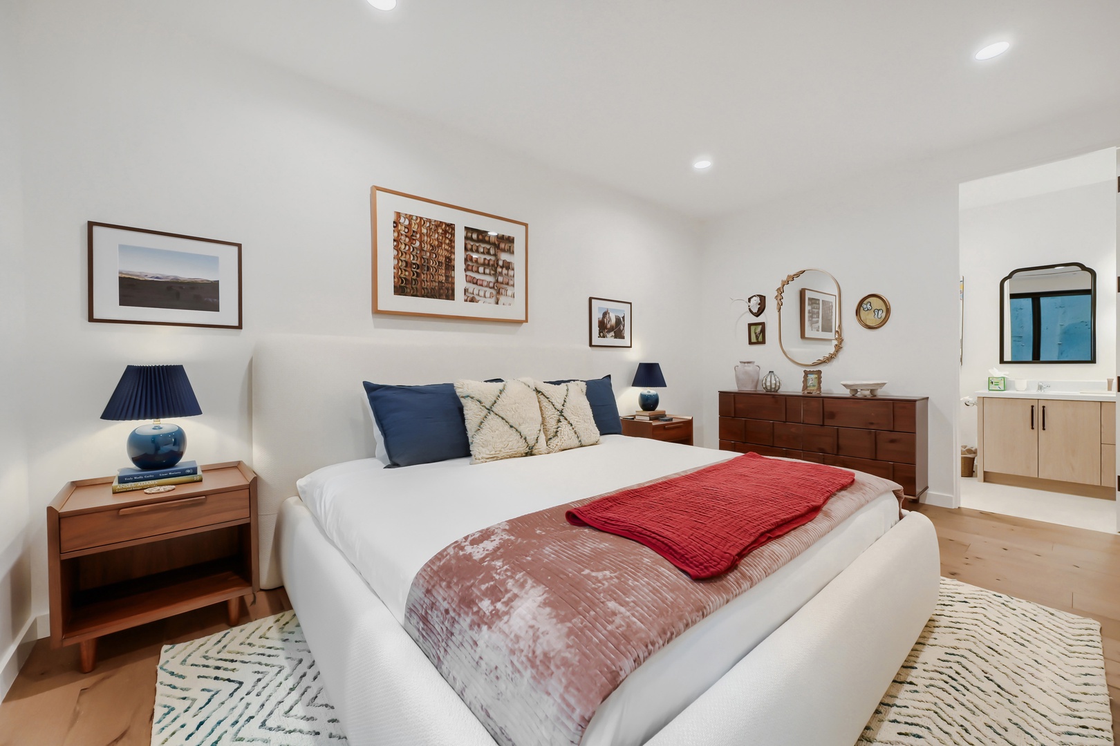 Sink into the plush comfort of your modern bedroom, where thoughtful design meets relaxation. Soft lighting and warm wood tones create a welcoming retreat after your day's adventures.