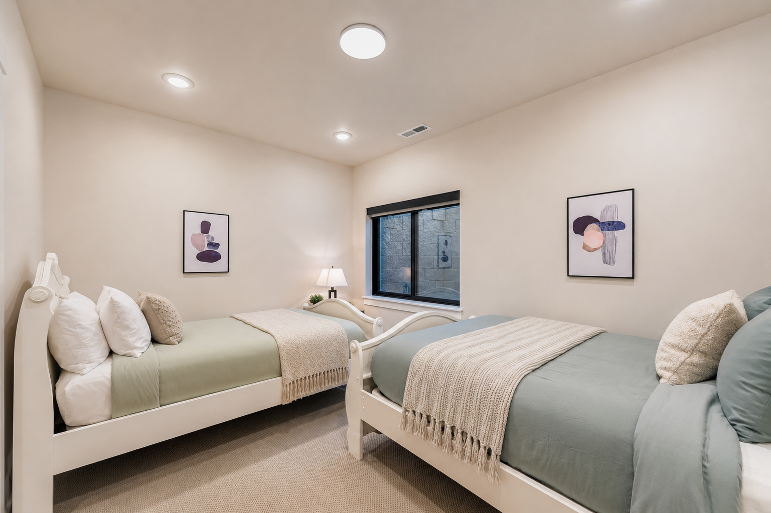Drift off to sleep in this serene bedroom, where two cozy beds with soft linens and plush throws await you and your travel companion. Gentle lighting and calming artwork create the perfect retreat.