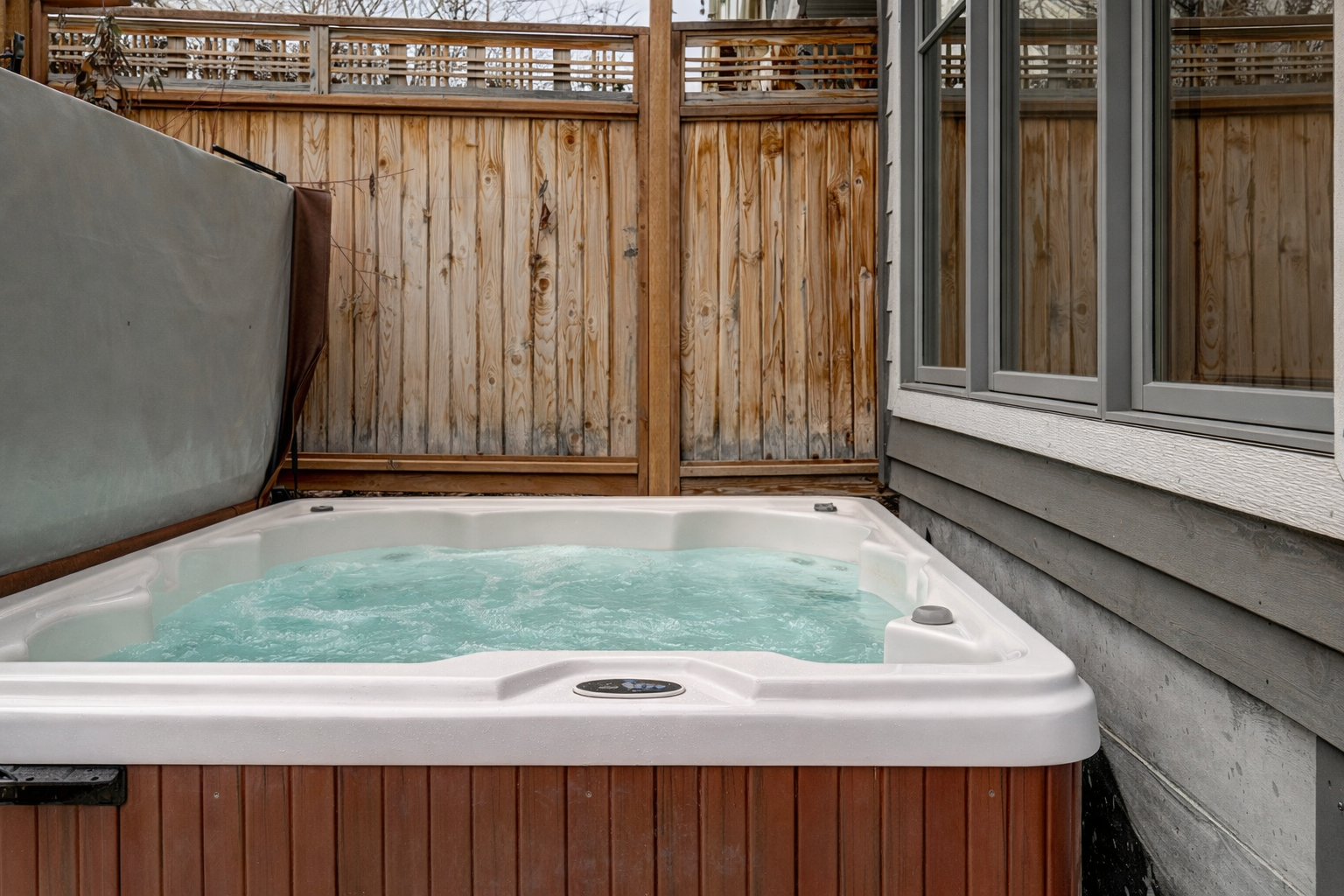 Soak your stresses away in your private hot tub, surrounded by warm wood fencing for complete relaxation.