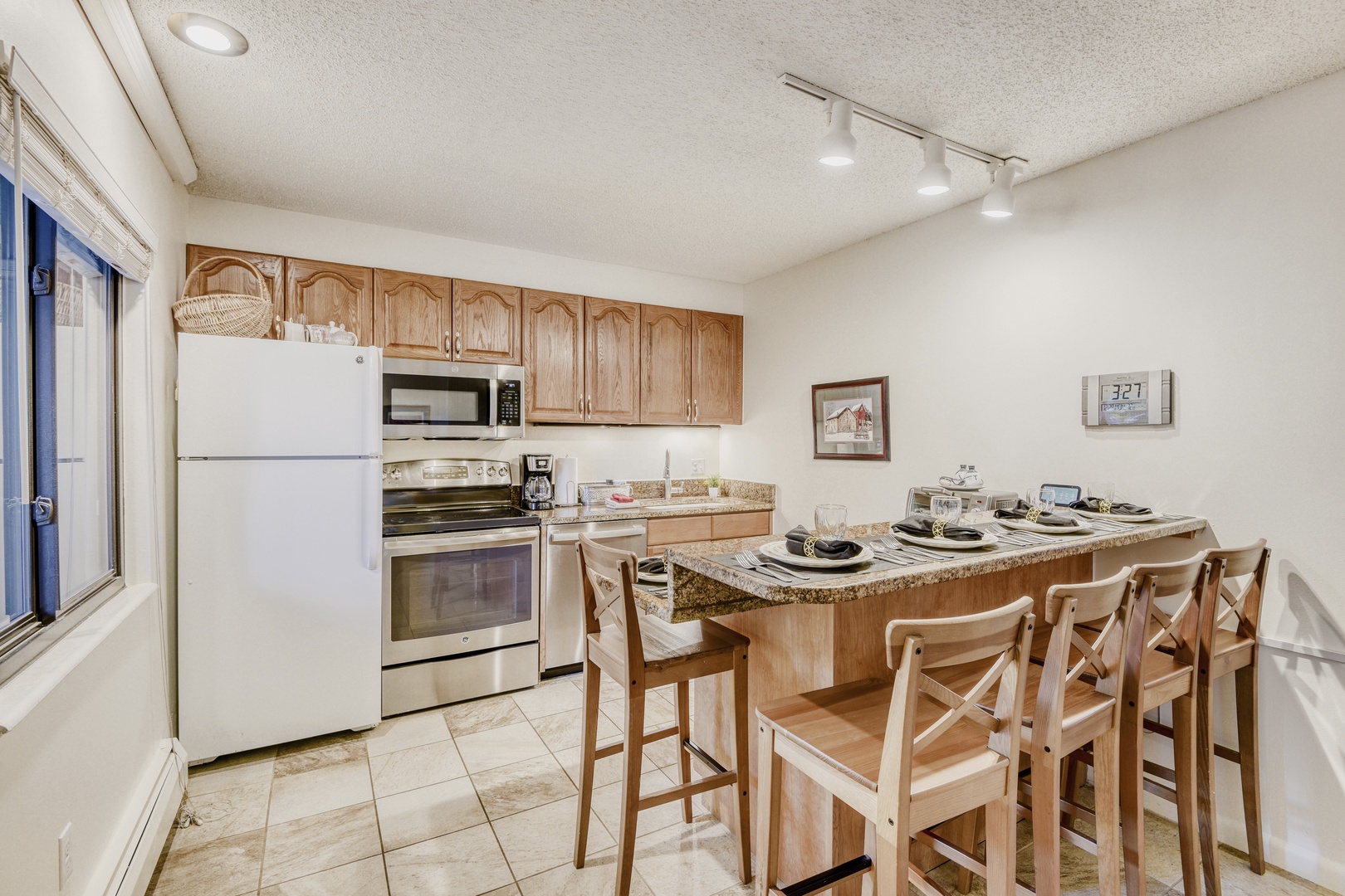 Your fully equipped kitchen features granite countertops and breakfast bar seating where you can enjoy home-cooked meals together.