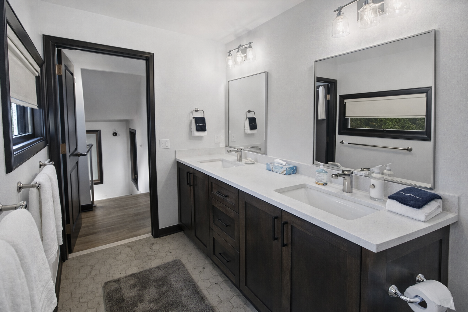 Spacious modern bathroom with a large double vanity and a convenient tub/shower combo. Sparkling clean and bright for a refreshing start to your day.