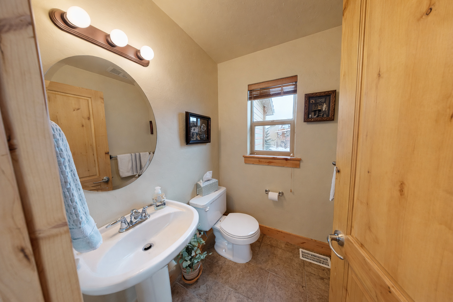 Your private bathroom features warm wood accents and thoughtful touches, creating a cozy retreat for your morning routine.