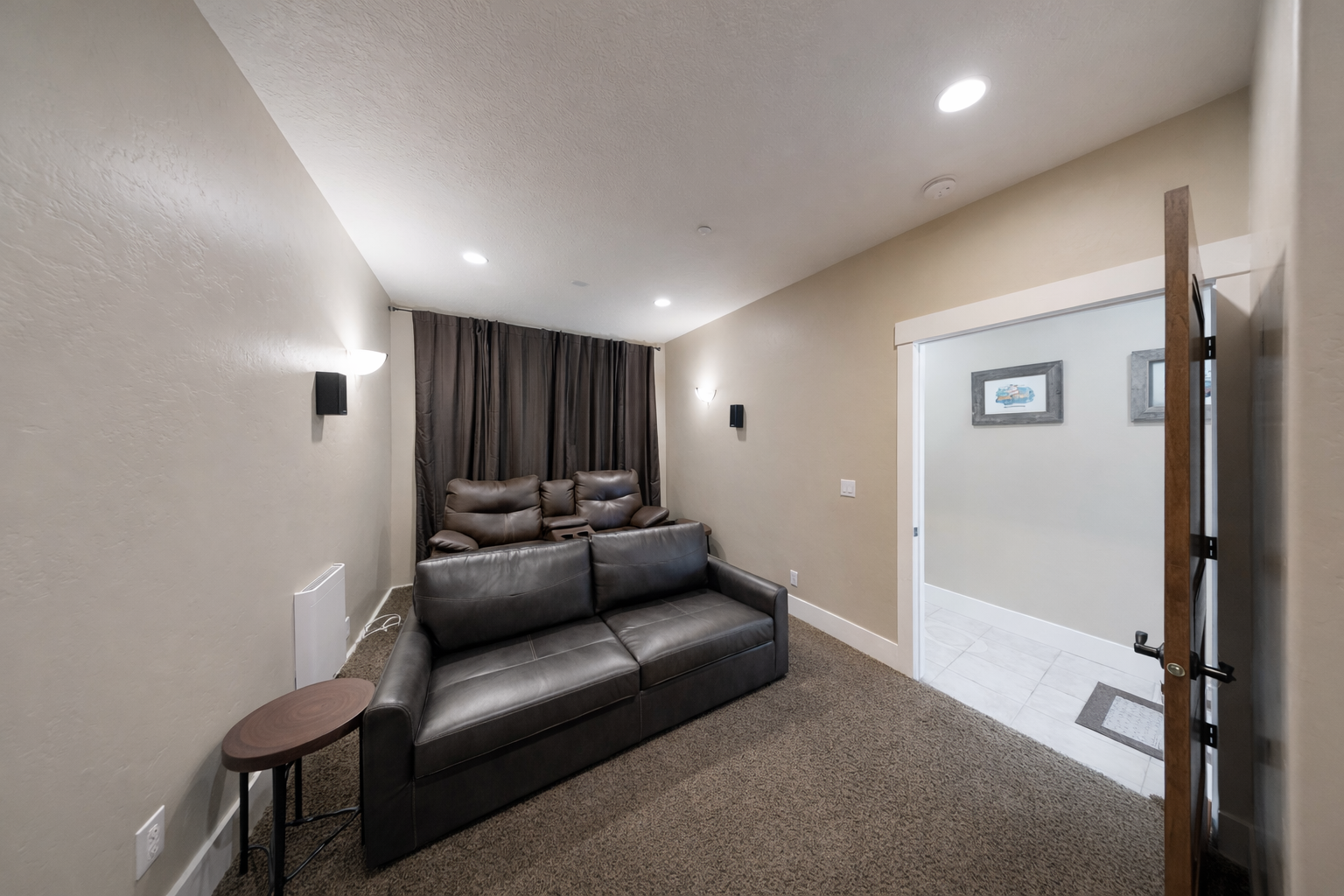 Sink into plush leather recliners and enjoy movie nights on your large flat-screen TV in this cozy entertainment space.