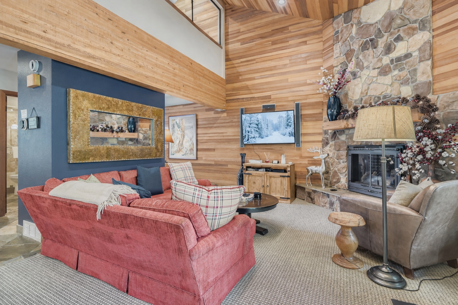 Curl up by your crackling fireplace in this cozy mountain retreat, where warm wood accents and comfortable seating create the perfect après-ski atmosphere.
