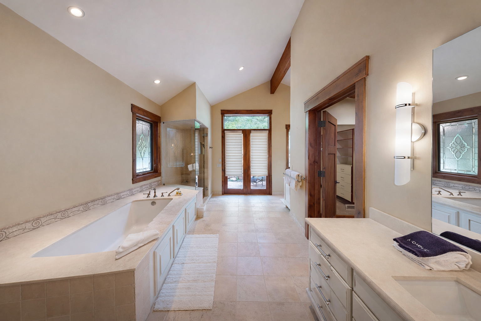 Unwind in your luxurious master bathroom with elegant marble countertops, a deep soaking tub, and warm wood accents creating the perfect spa-like retreat.