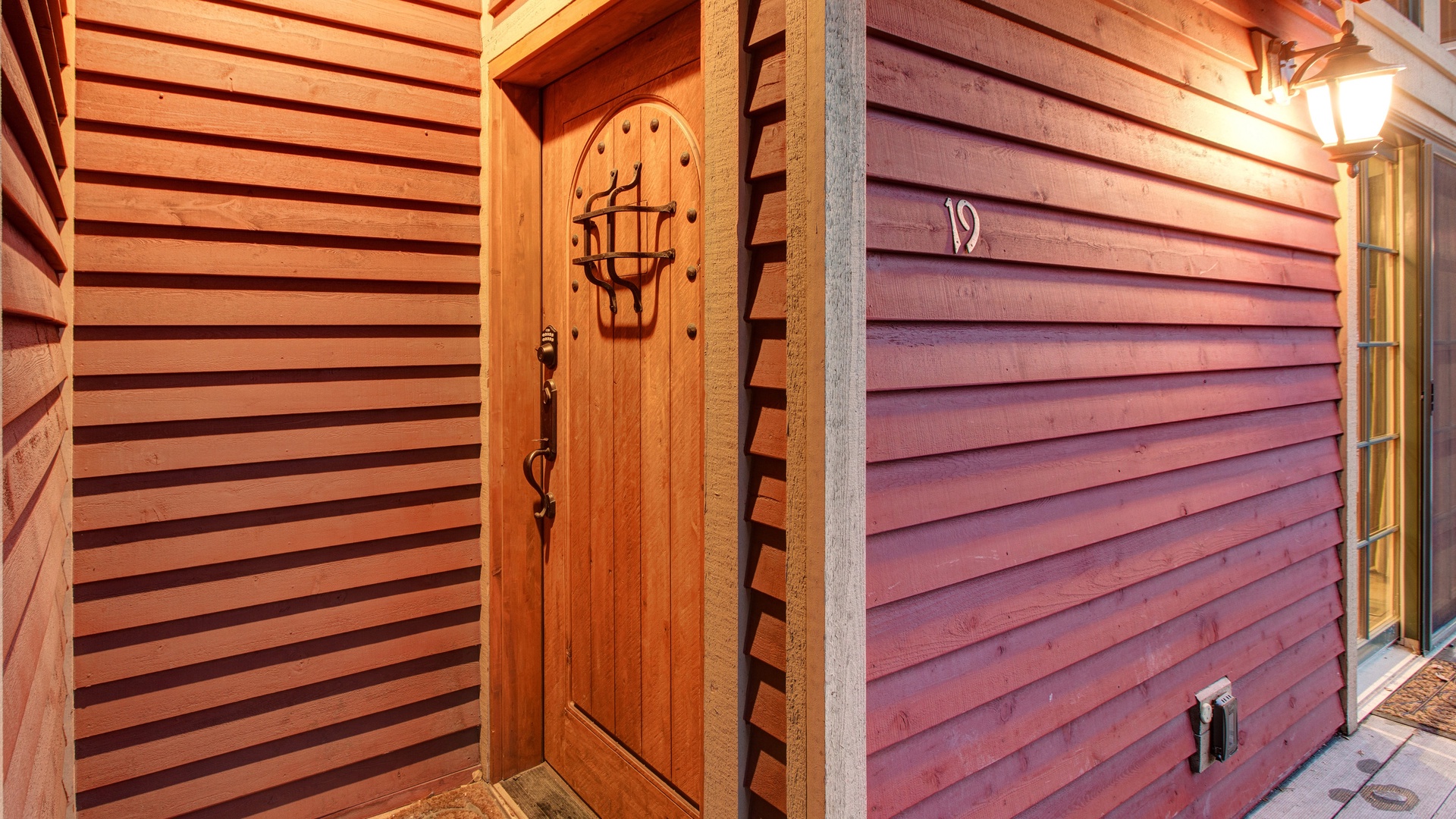 Your private entrance welcomes you with warm wood siding and charming architectural details.
