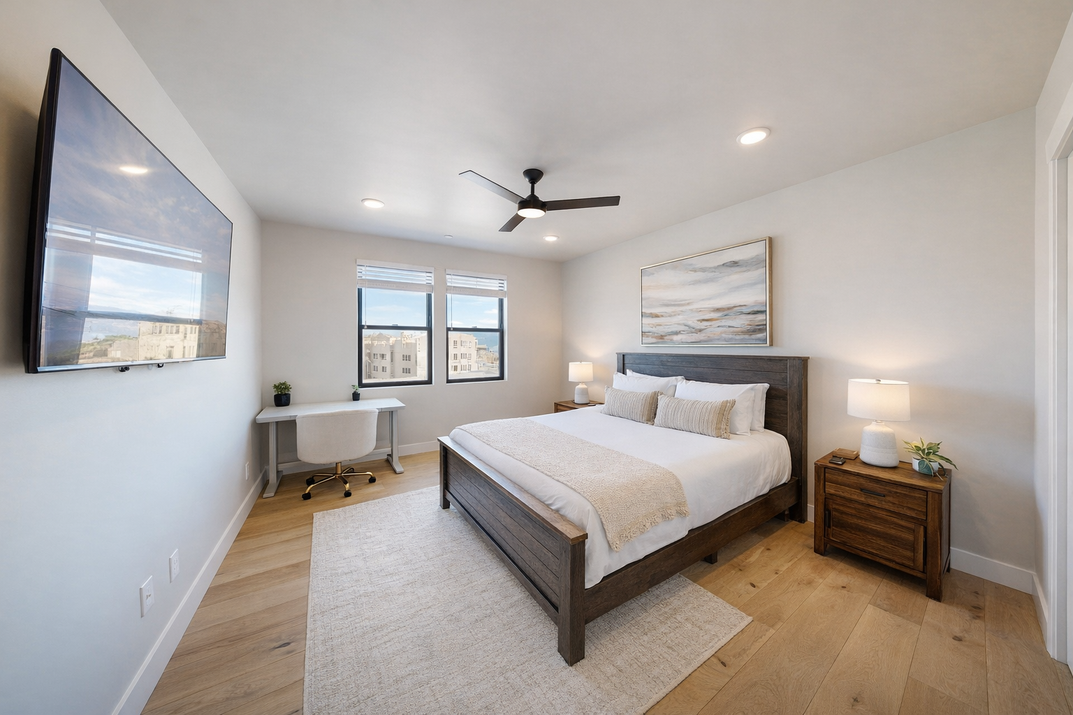 Sink into crisp white linens and wake refreshed in your serene bedroom with modern coastal vibes and warm wood accents.