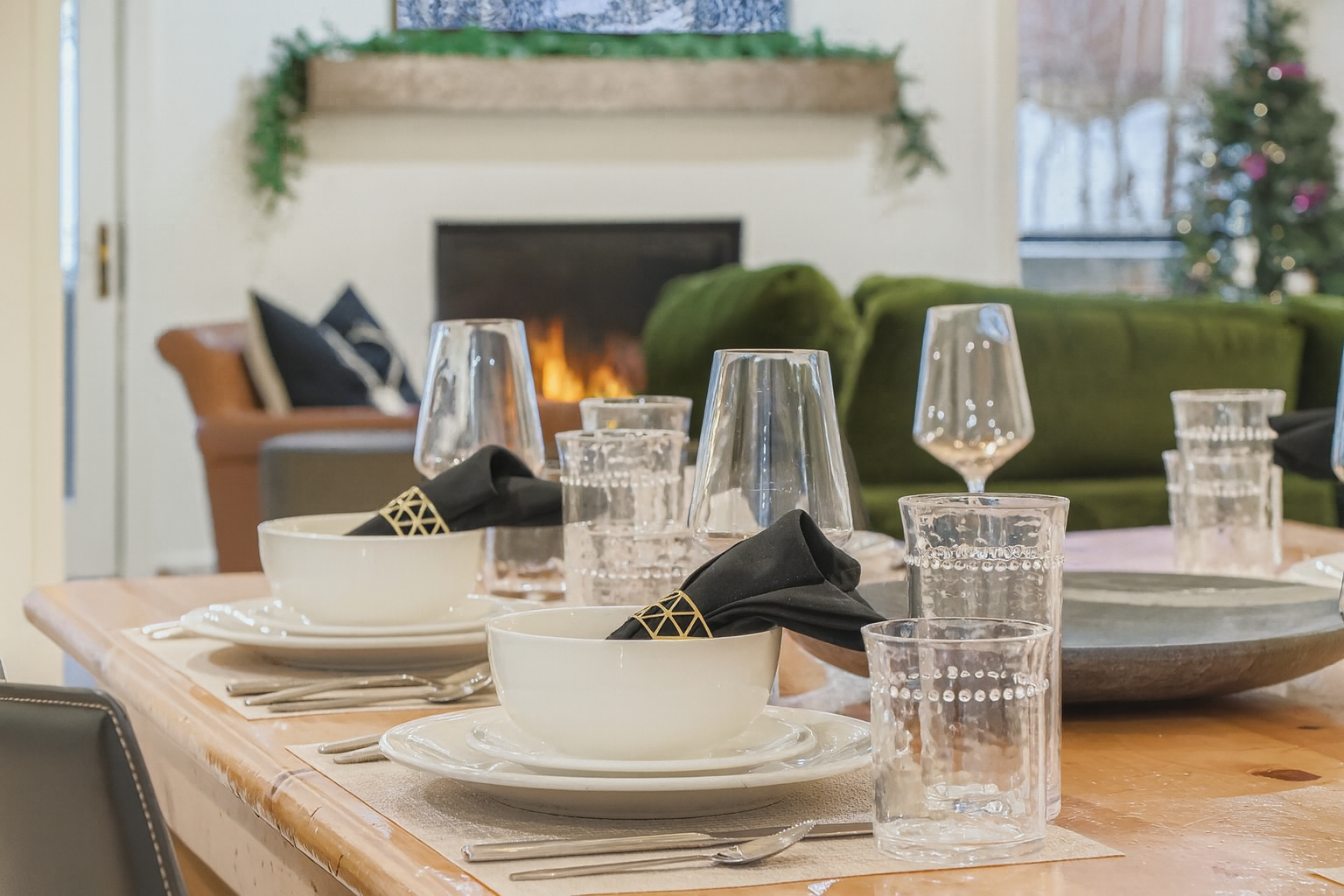 Your elegant dining table awaits with crisp linens and sparkling glassware, set against the warm glow of your cozy fireplace.