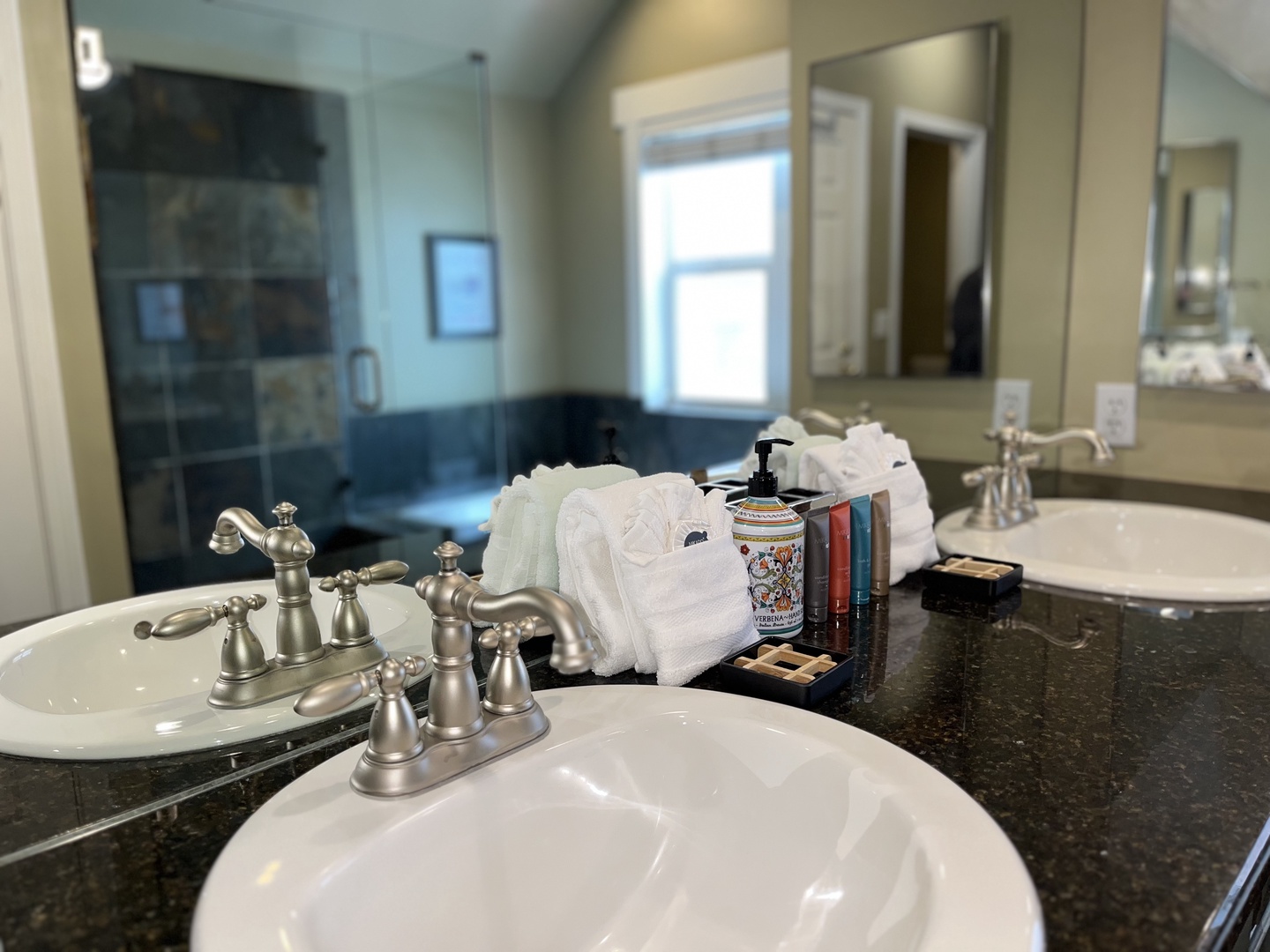Indulge in the spa-like master bathroom, featuring a double vanity with dark granite countertops and a large jetted soaking tub. It's the perfect place to recharge after a day of adventure.