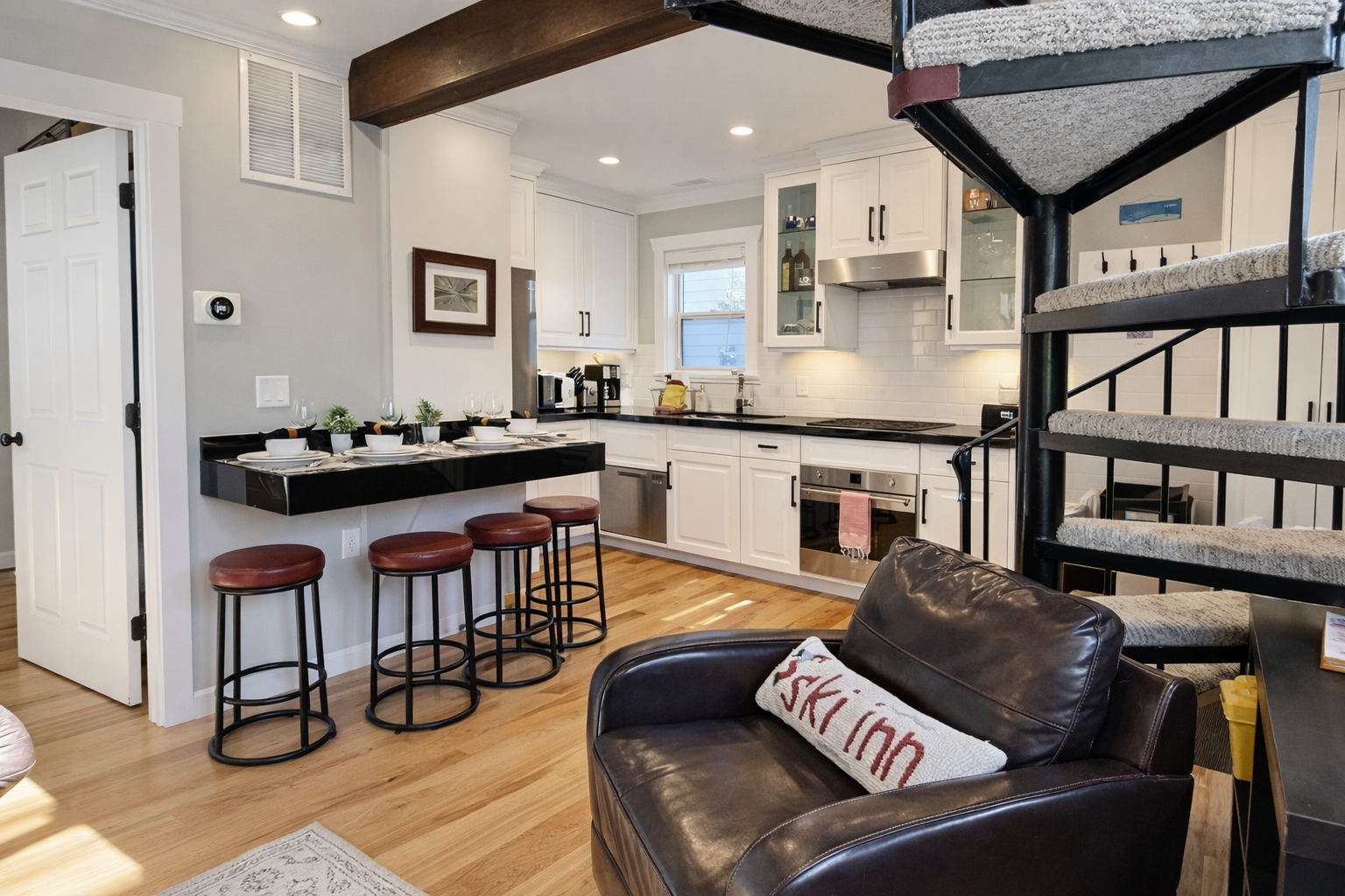 Step into your modern retreat where exposed beams meet sleek design. Cook in the fully equipped kitchen while friends gather at the breakfast bar.