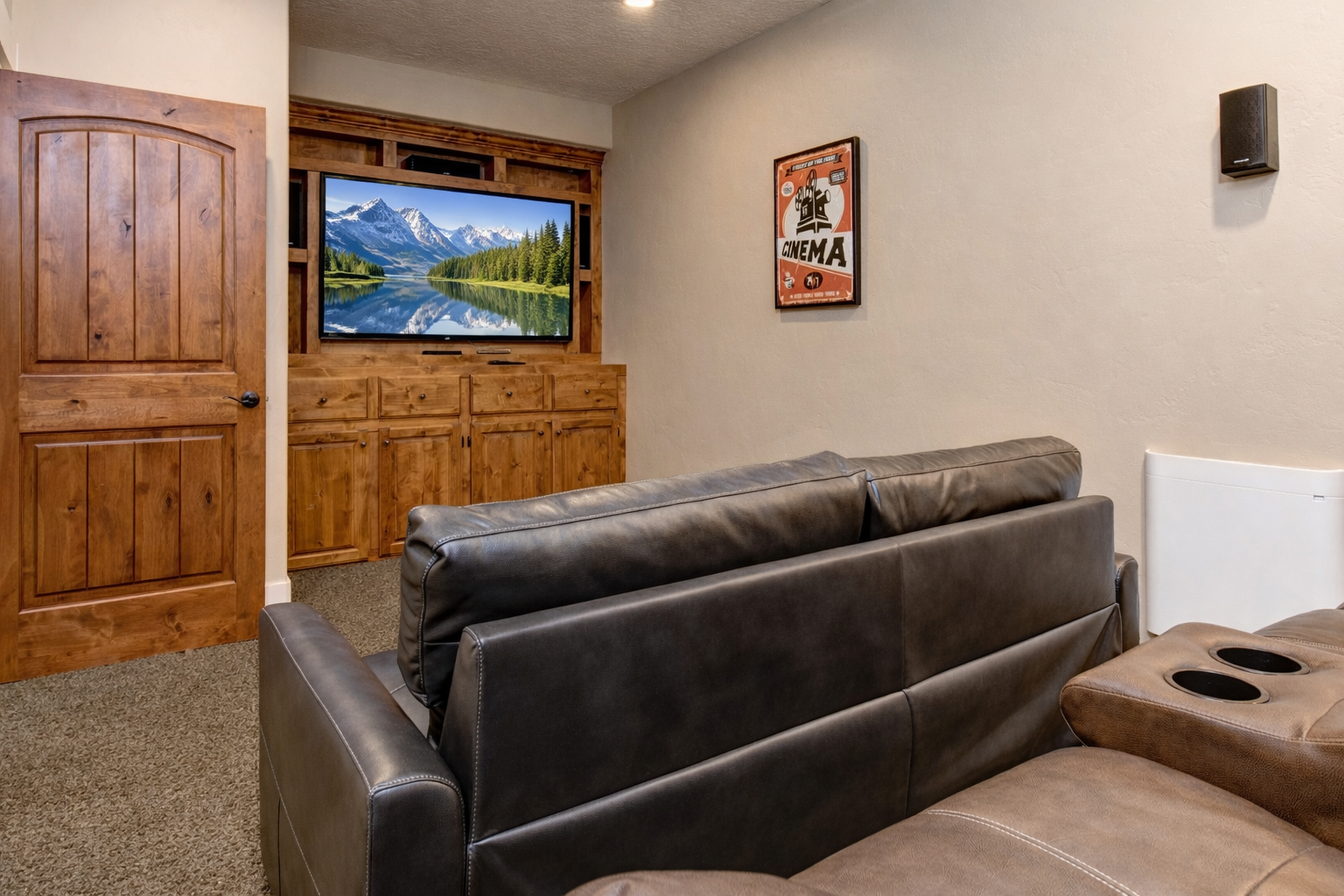 Sink into plush leather recliners and enjoy movie nights on your large flat-screen TV in this cozy entertainment space.