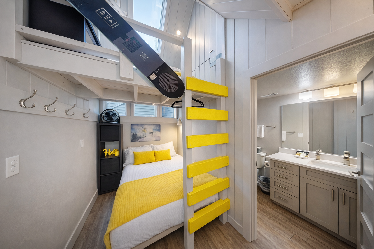 Maximize your stay in this bright, modern suite. Offering a unique bunk setup, plush yellow accents, and dedicated storage, it's a cozy haven designed for both kids and adults.