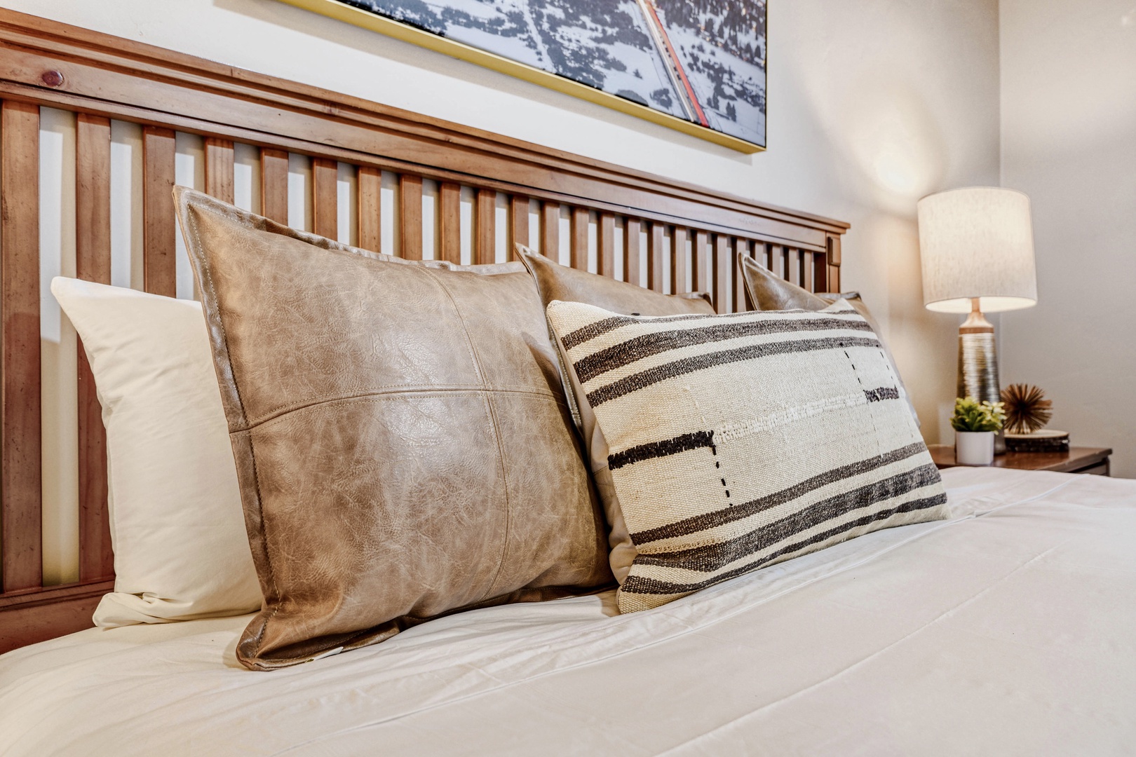 Sink into plush pillows and crisp linens in your cozy bedroom retreat, where warm wood tones create the perfect mountain-inspired atmosphere.