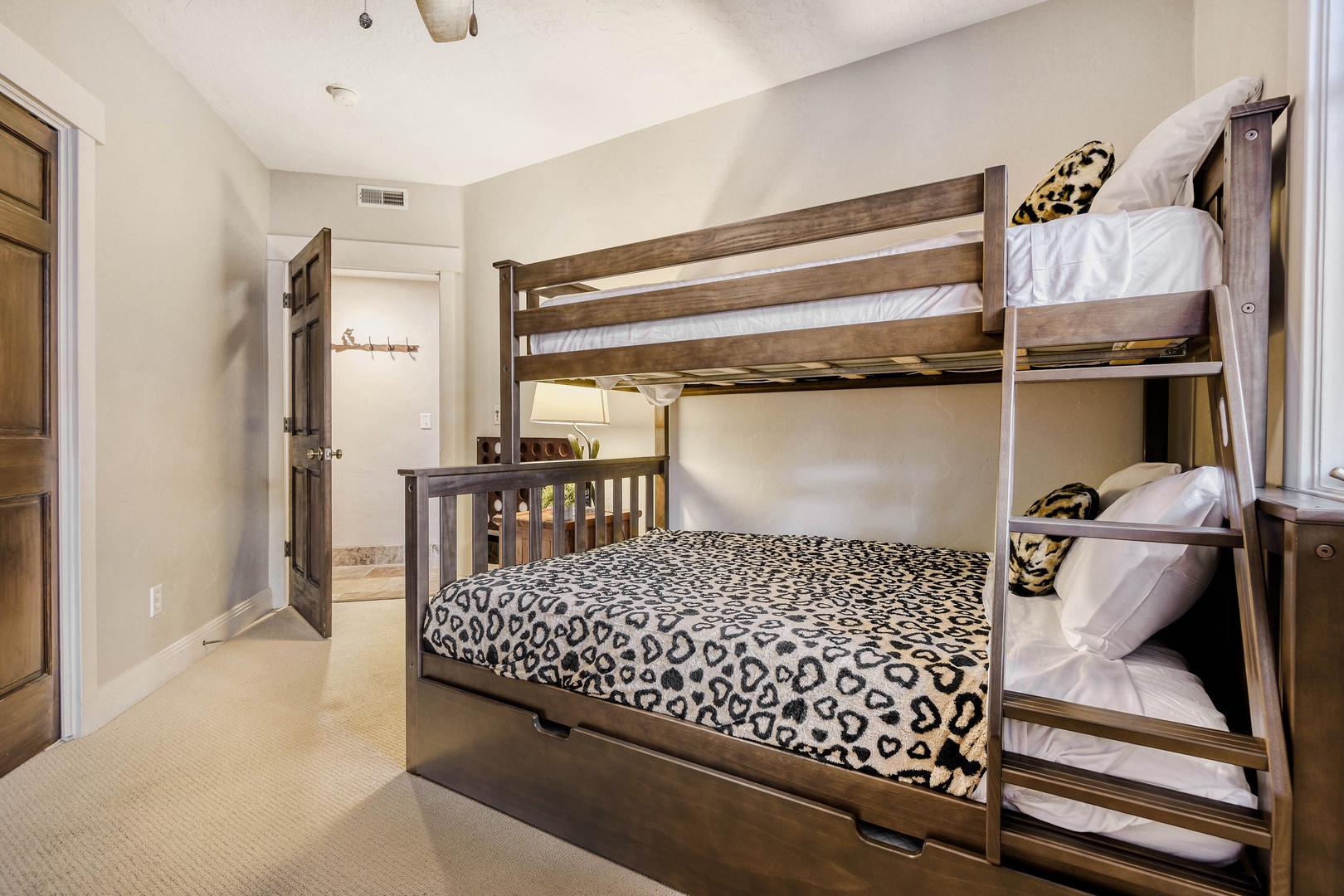 Your cozy bunk room with leopard-print bedding offers comfortable sleeping for multiple guests, perfect for family adventures.