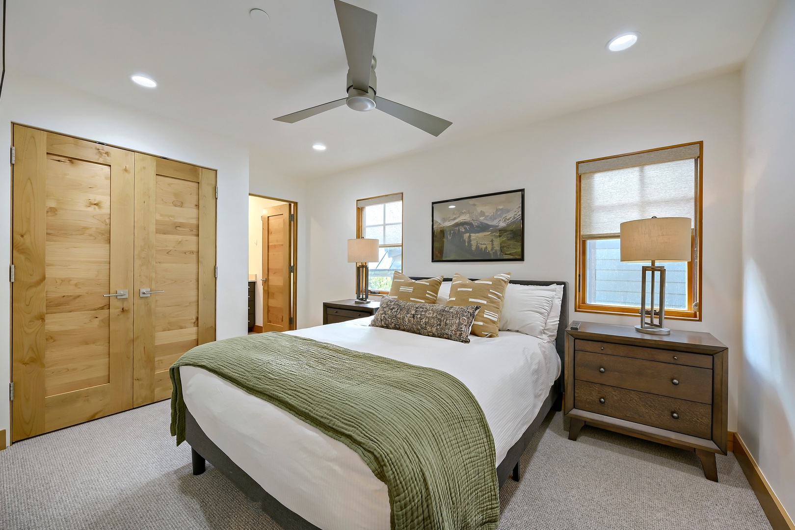 Drift off in your serene bedroom with plush linens, natural wood touches, and a soft ceiling fan breeze. Mountain views and calming tones invite restful nights.
