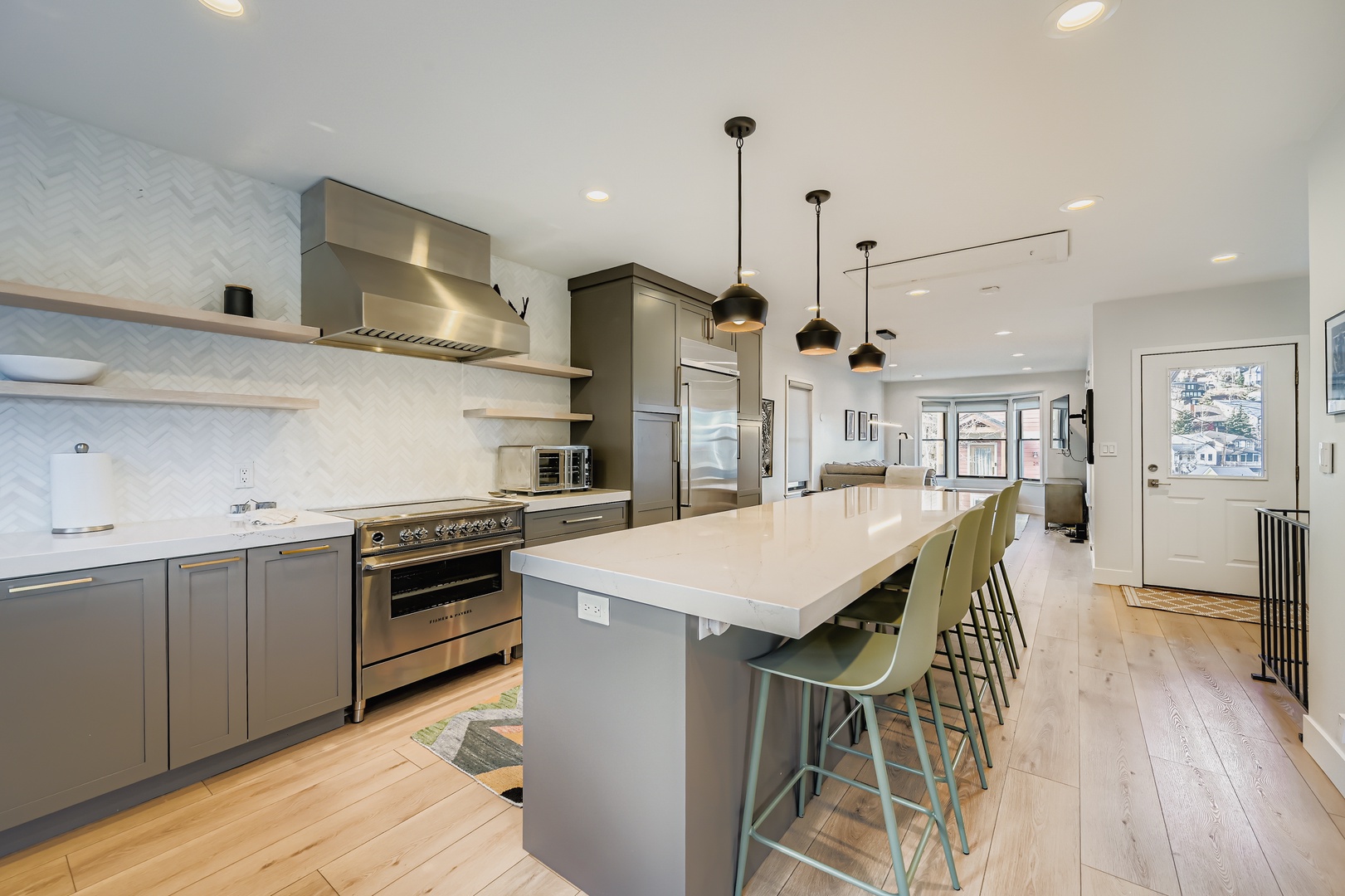 Your modern kitchen features a spacious island for gathering, stylish pendant lighting, and open shelving that adds warmth. Everything you need to cook and connect is right here.