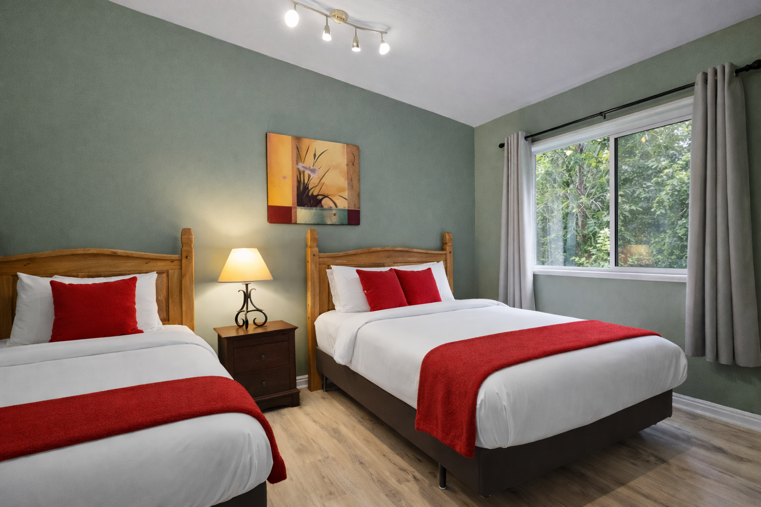 Comfortable & modern double room with stylish red accents, wood flooring, and large windows. A relaxing space for your Park City stay.