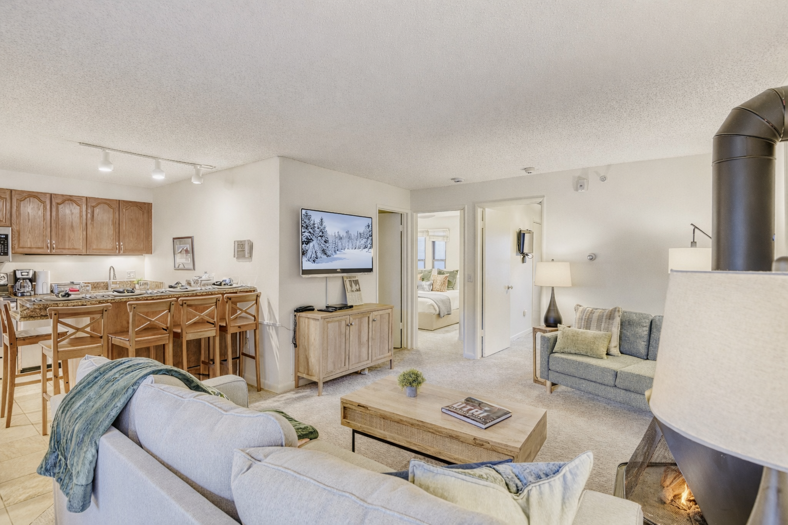 Sink into plush sofas by your crackling fireplace while you enjoy open-concept living that flows seamlessly from kitchen to cozy retreat.