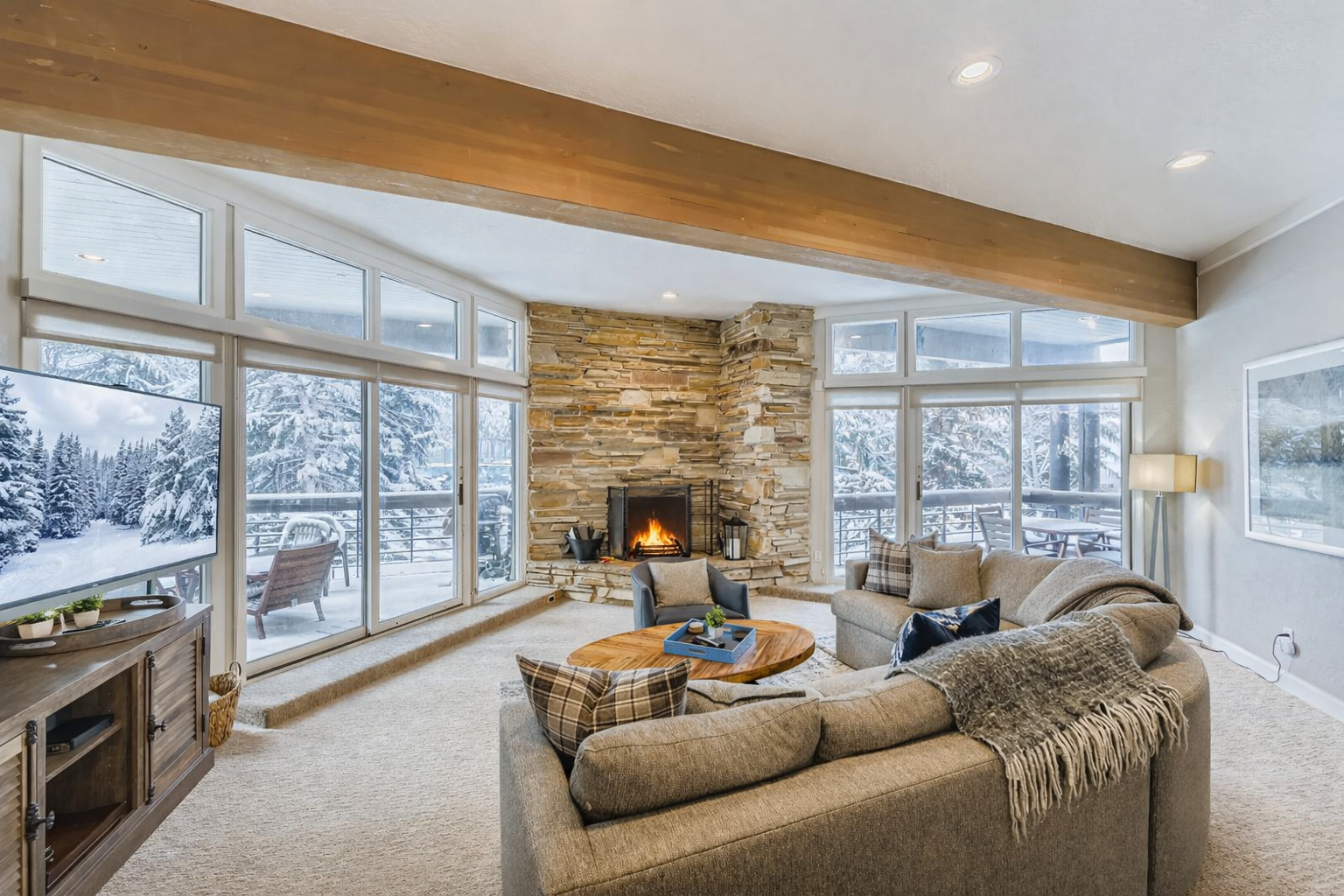 Relax in your spacious living area featuring a comfortable sectional sofa, stylish coffee table, and an open-concept layout that flows seamlessly into the fully equipped kitchen.