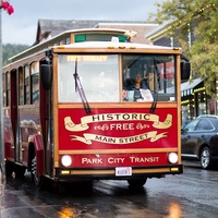 Historic red trolley car provides charming public transportation through the city streets.