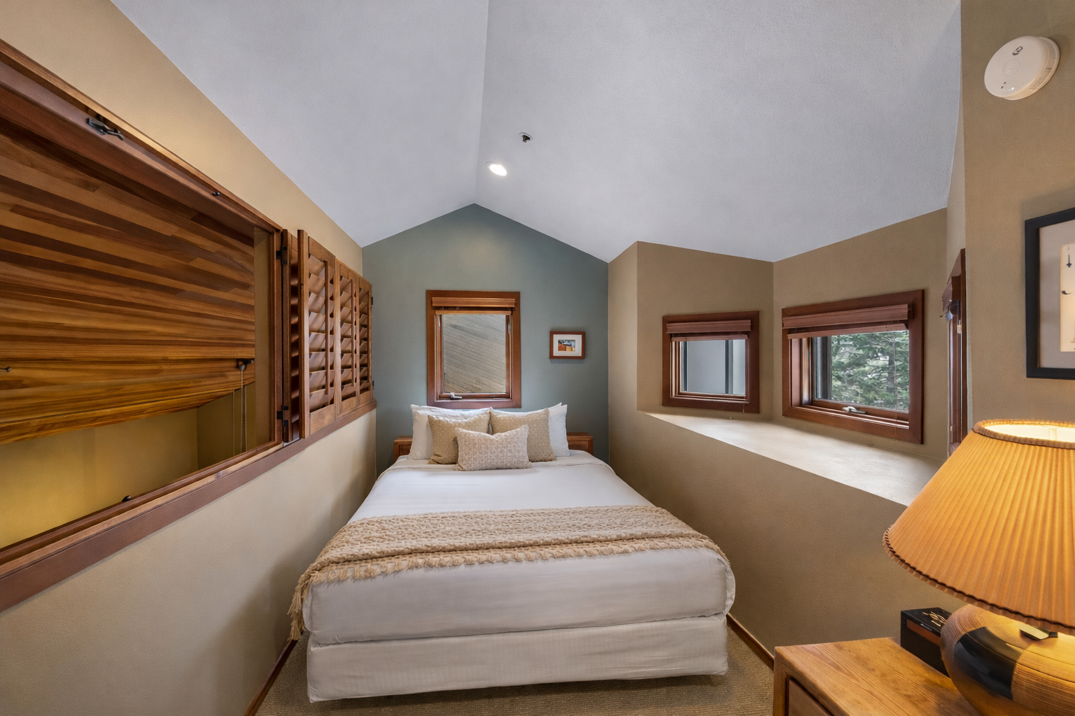 Step into your serene bedroom with warm wood finishes, cozy bedding, and thoughtful lighting that creates the perfect retreat.