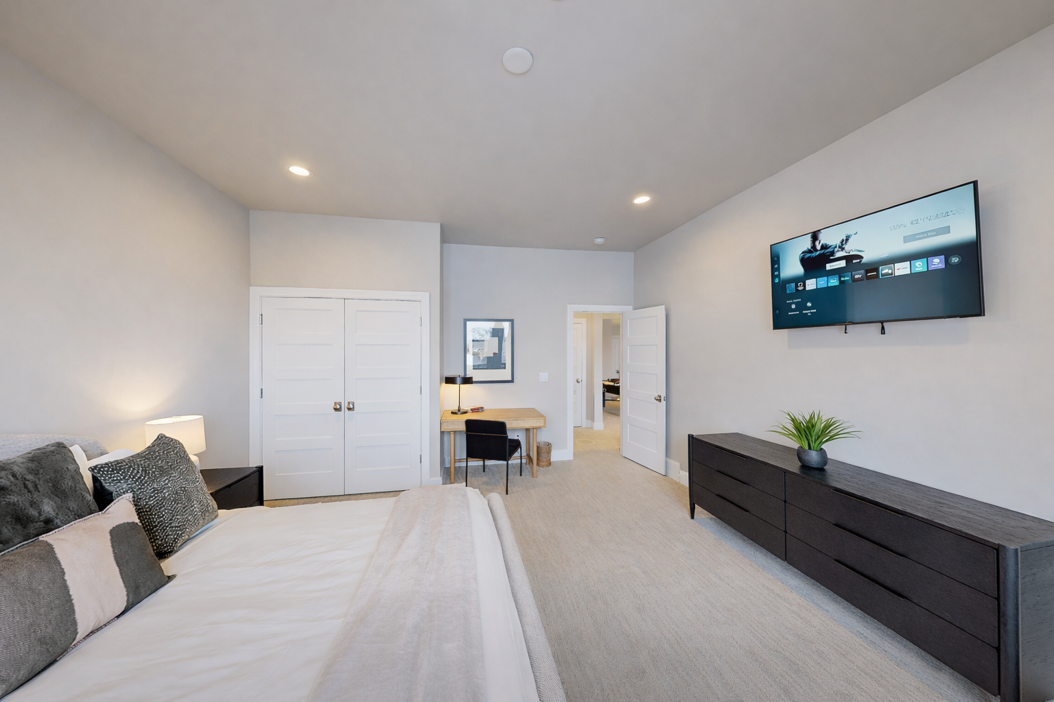 Unwind in your spacious living room with plush seating, wall-mounted TV, and modern storage—perfect for cozy evenings.