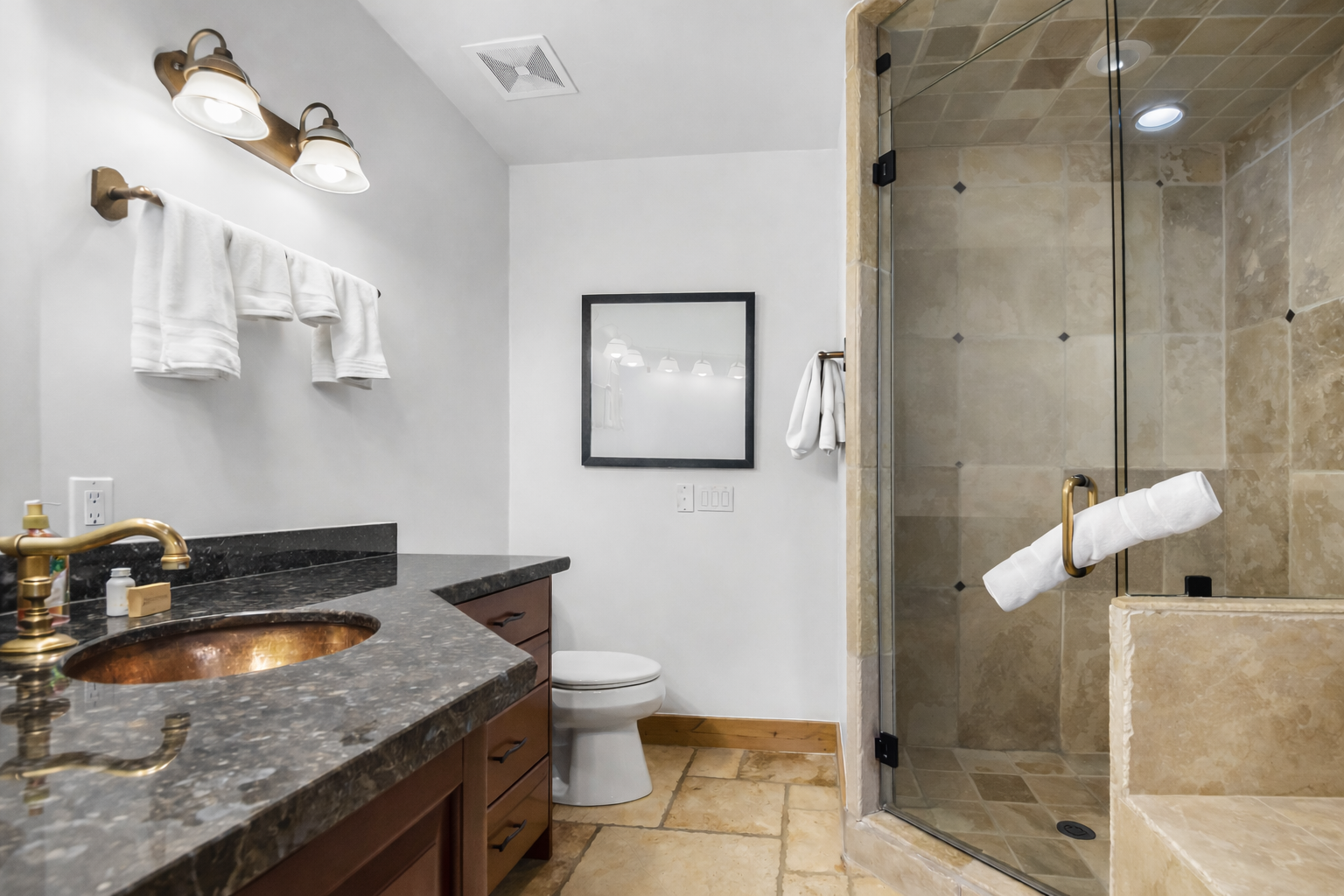Your spa-like Primary Ensuite bathroom features a luxurious walk-in shower with elegant stone tiles and a beautiful copper basin sink for ultimate relaxation. Unit A