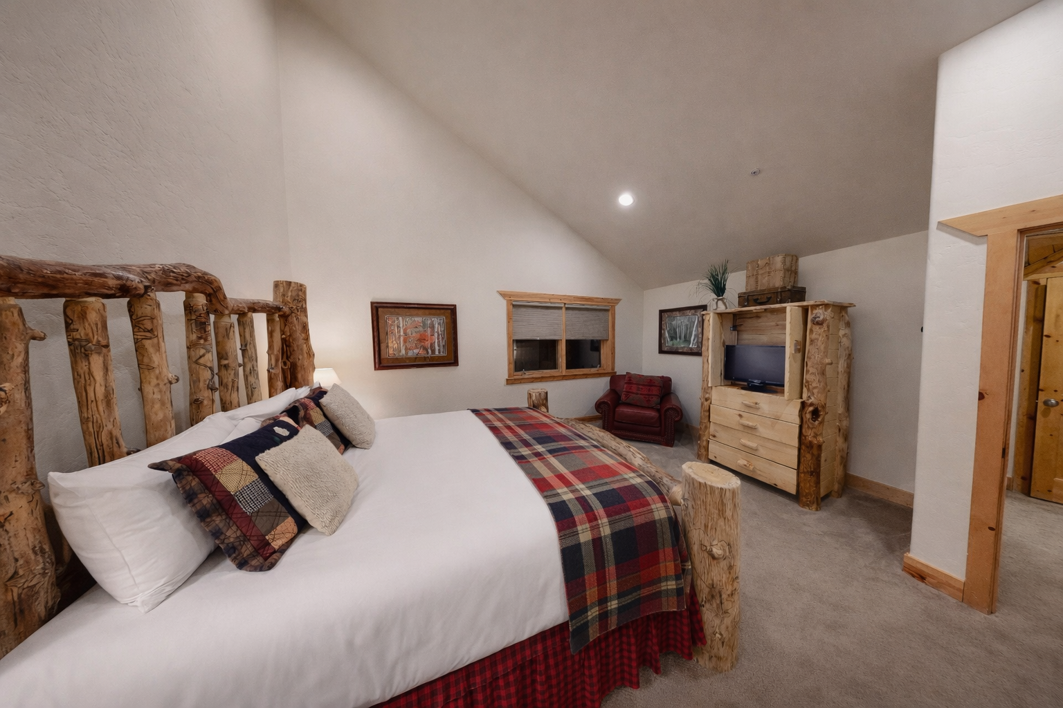 Your rustic retreat awaits with handcrafted log furniture, cozy plaid accents, and modern amenities perfectly blended for mountain comfort.