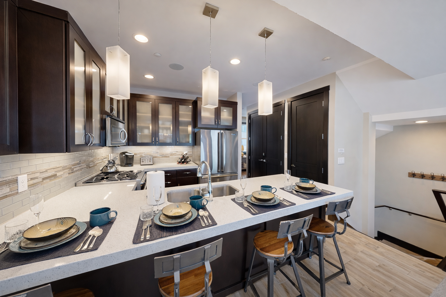 This modern open-concept living space features a fully equipped kitchen with sleek cabinetry and a spacious dining island