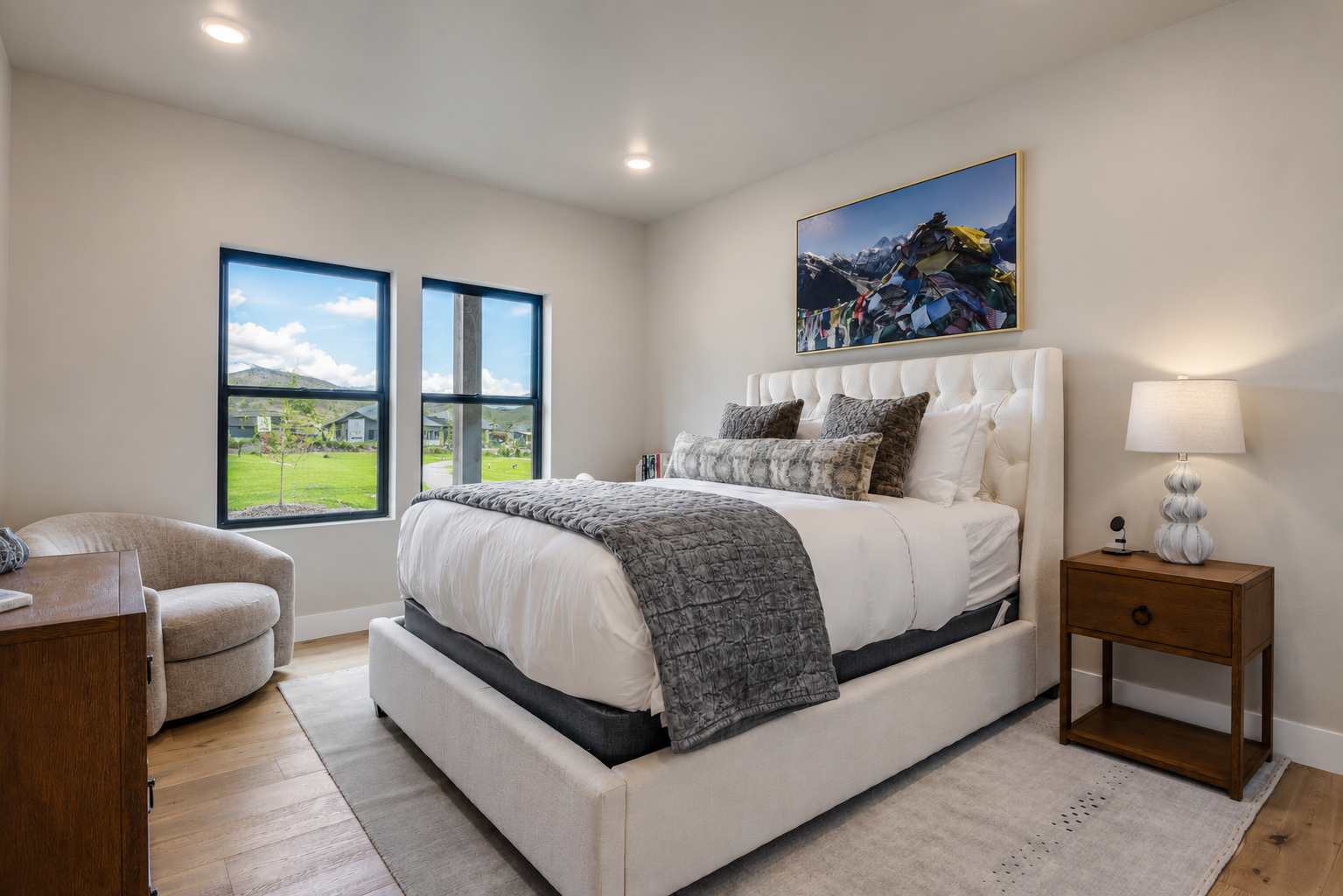 Sink into your plush bed overlooking rolling green hills and distant mountains—your peaceful retreat with a view, soft linens, and cozy mountain-inspired accents awaits.