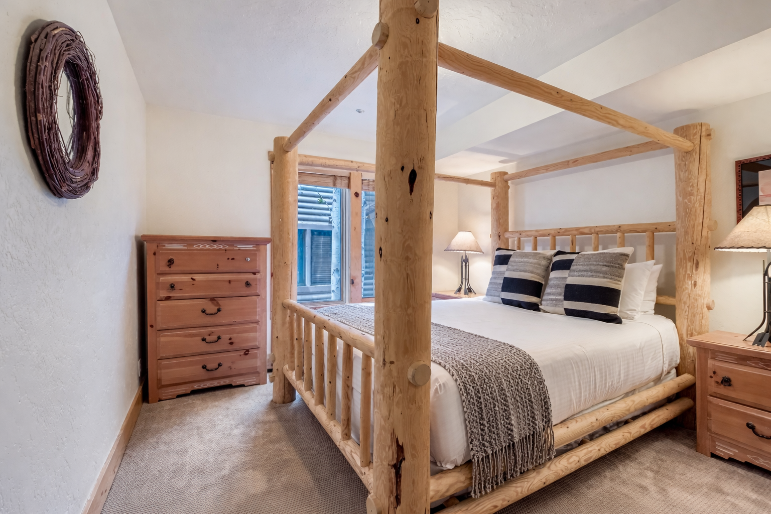 Unwind in your rustic four-poster bed, where handcrafted wood meets cozy textures for the perfect countryside retreat.