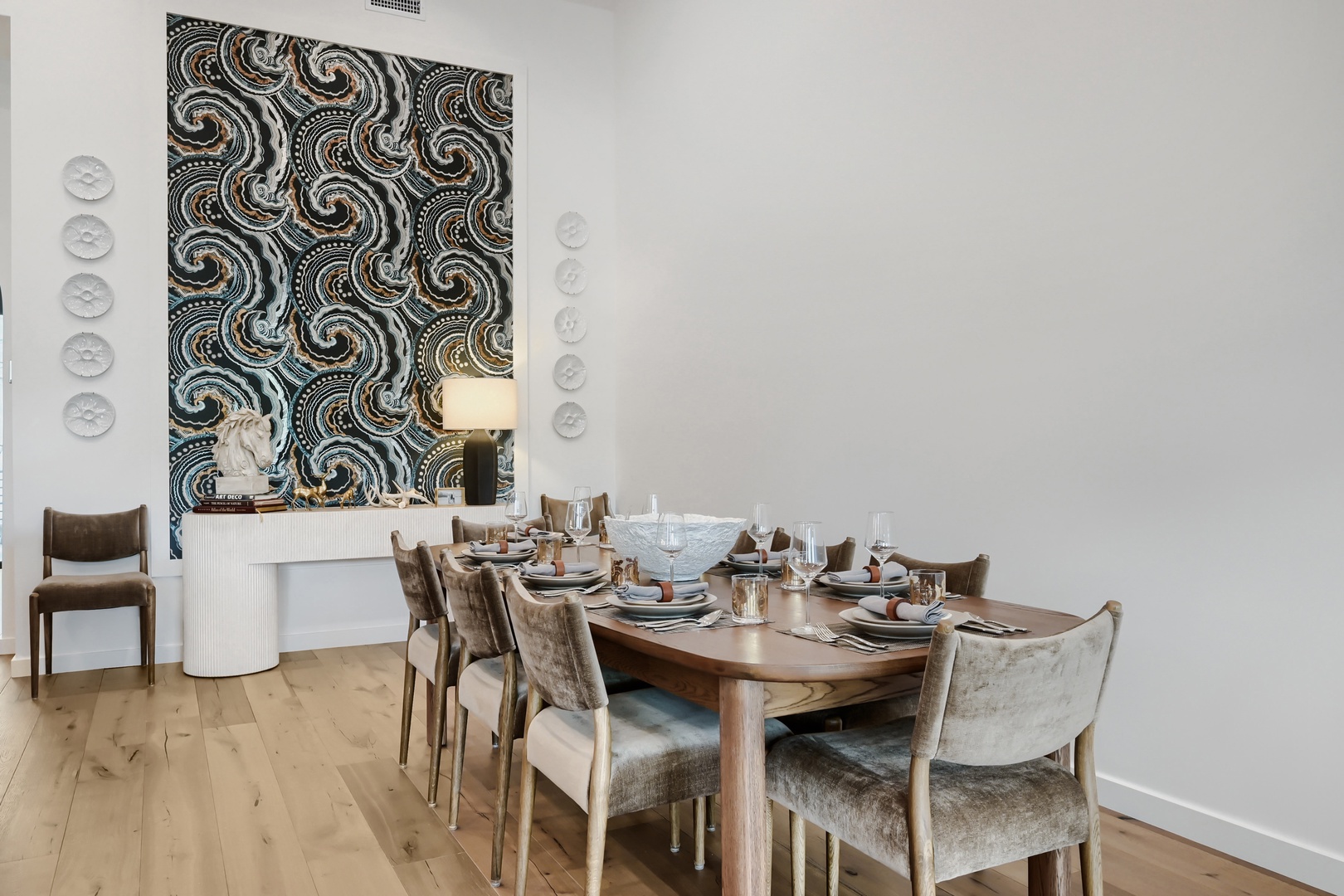 An elegant dining table set for a gathering, featuring artful decor and refined furnishings that create a sophisticated atmosphere for your memorable meals together.