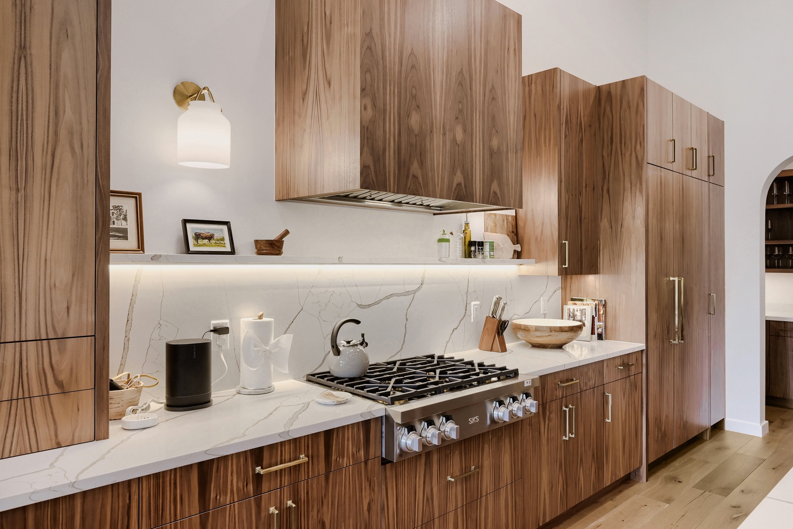Your gourmet kitchen awaits with gleaming marble countertops, a professional gas range, and rich wood cabinetry perfect for preparing meals during your stay.