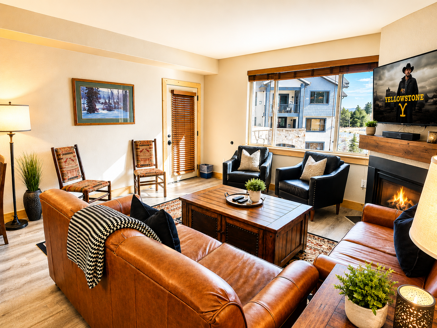 Sink into rich leather furniture as the fireplace crackles warmly beside you. Large windows frame mountain views, while rustic touches create a welcoming retreat after a day exploring.
