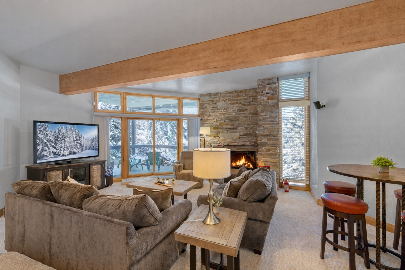 Cozy up by the crackling fireplace while you watch snow-covered peaks through expansive windows in your mountain retreat.