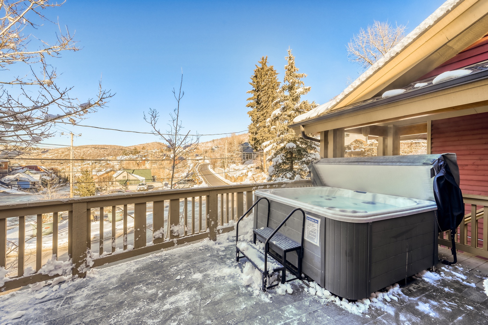 Soak in your private hot tub while winter mountain views create the perfect backdrop for relaxation.