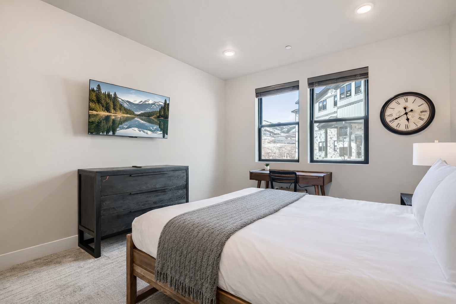 Unwind in your peaceful bedroom with plush bedding, modern amenities, and serene city views through large windows.