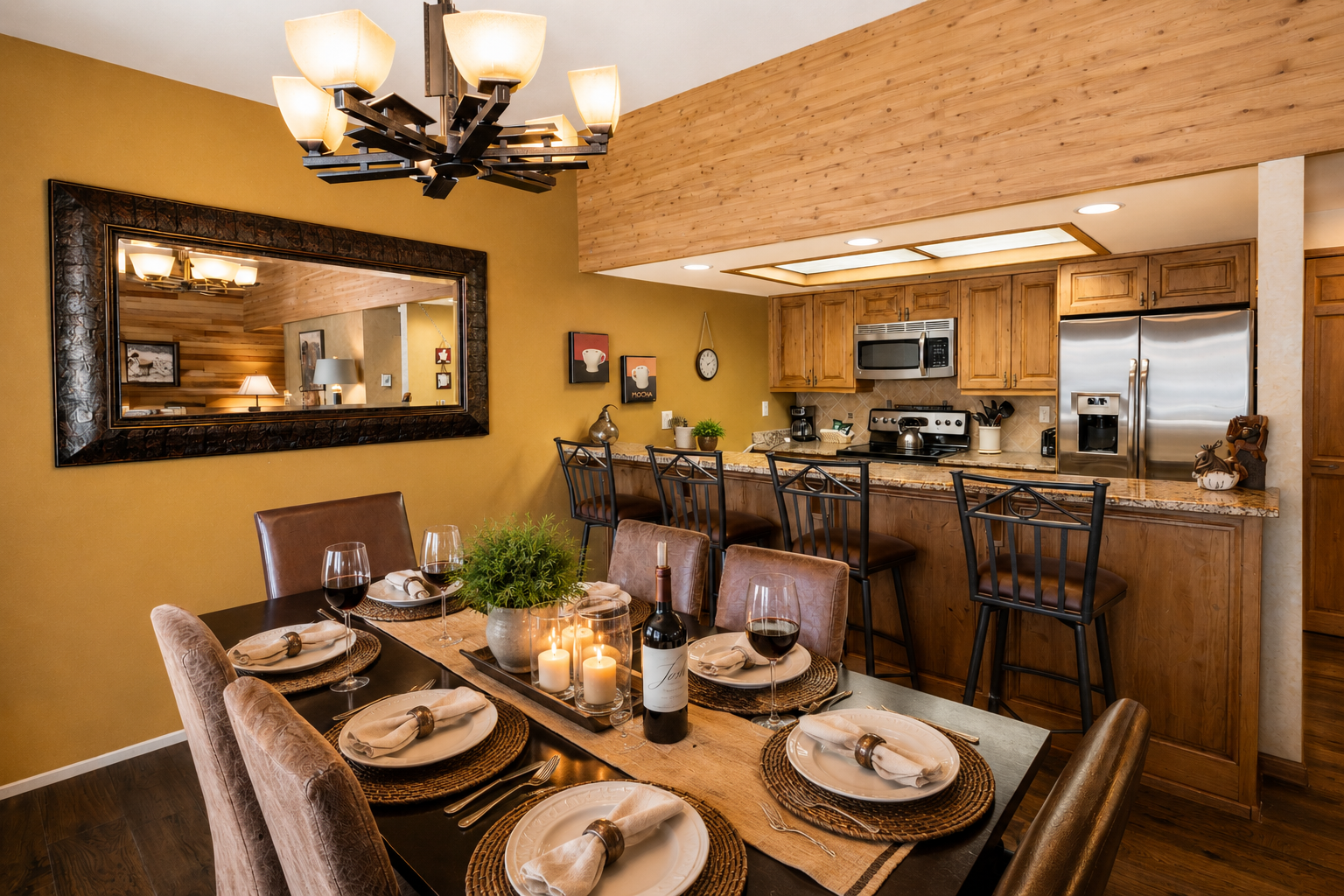 Gather around the warm, inviting dining space that flows seamlessly into your fully equipped kitchen, perfect for creating memorable meals and cozy evenings together during your mountain getaway.