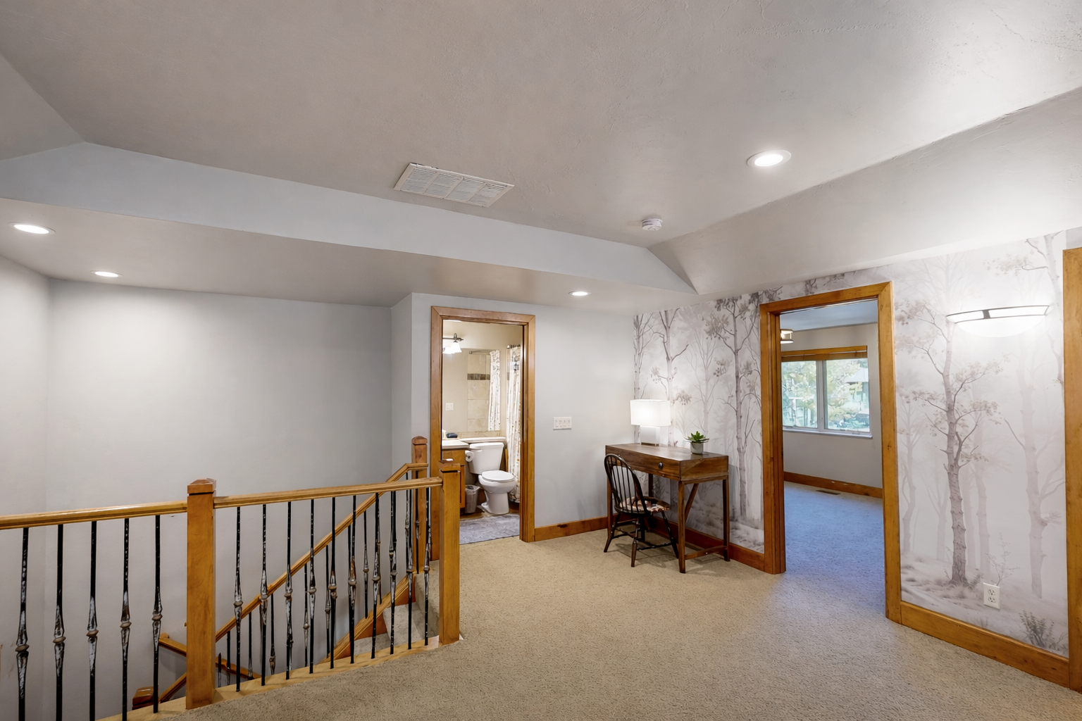 Charming upstairs landing with peaceful tree wallpaper creates your private workspace retreat with convenient access to bedroom and bath.