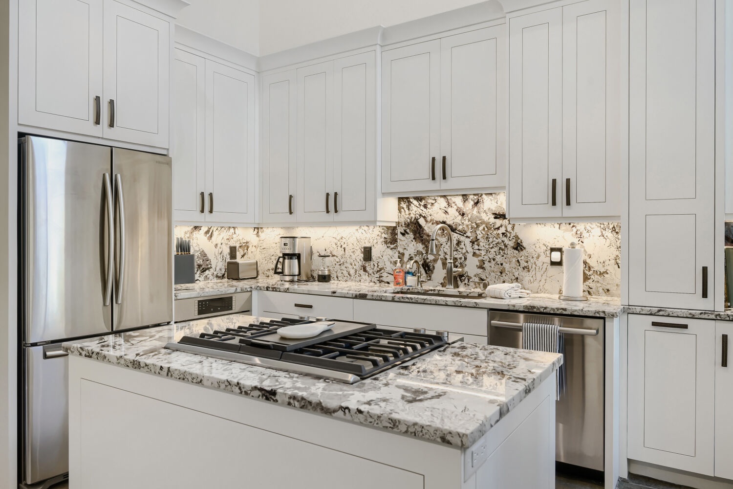 This bright, modern kitchen offers everything you need to prepare delicious meals. The granite countertops and stainless steel appliances make cooking a breeze, while the center island provides ample workspace for your culinary adventures.