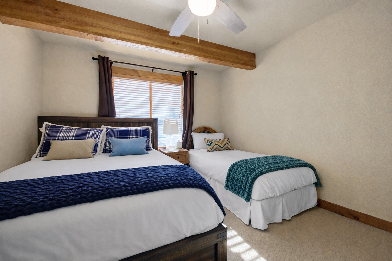 Unwind in your cozy bedroom featuring rustic wooden beams, comfortable beds with soft linens, and natural light streaming through the window.