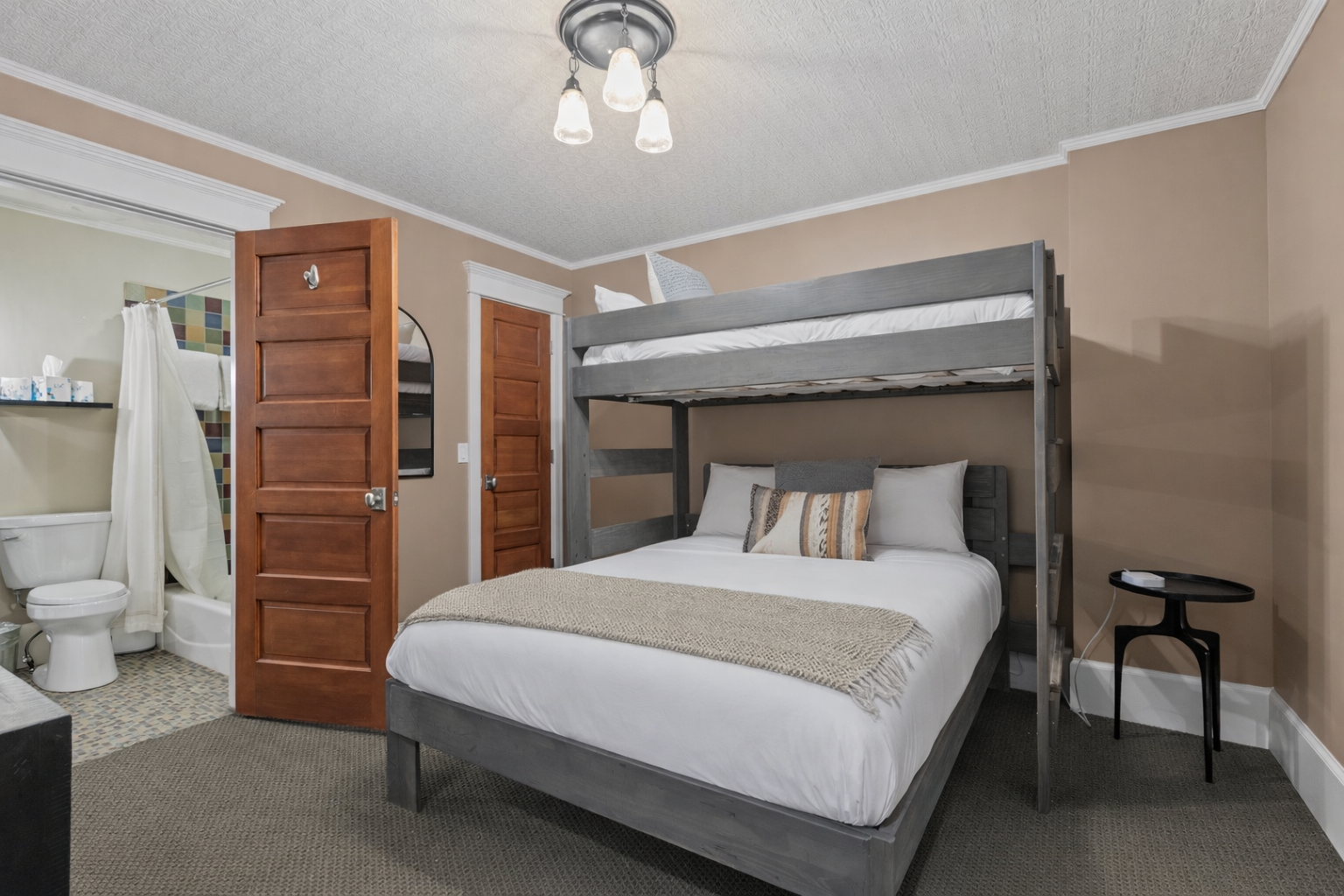 Cozy and functional, this room offers a comfortable bunk bed setup (double bottom, single top), perfect for families or groups.