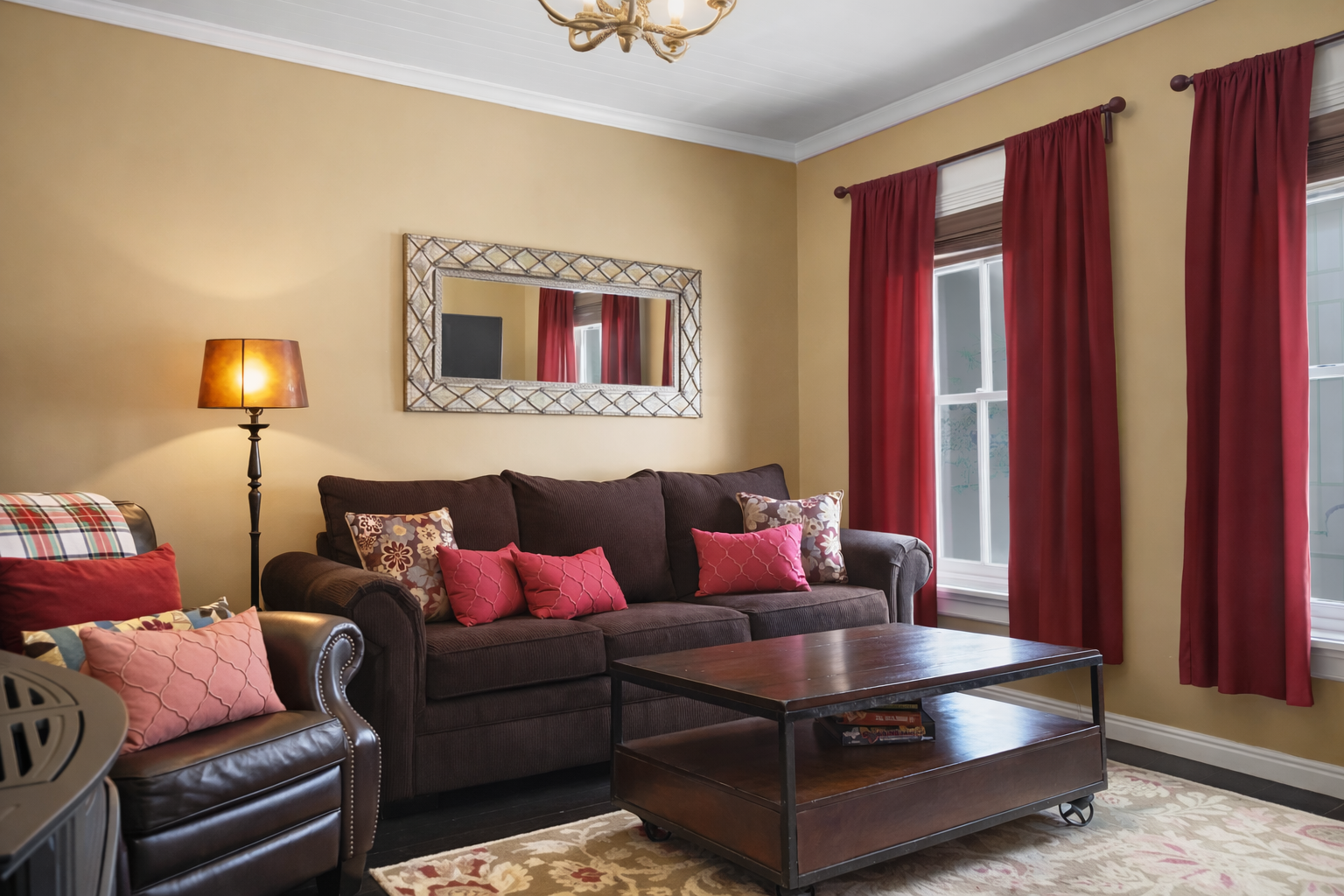 Unwind in your cozy living room with plush seating, entertainment center, and warm burgundy accents for relaxing evenings.