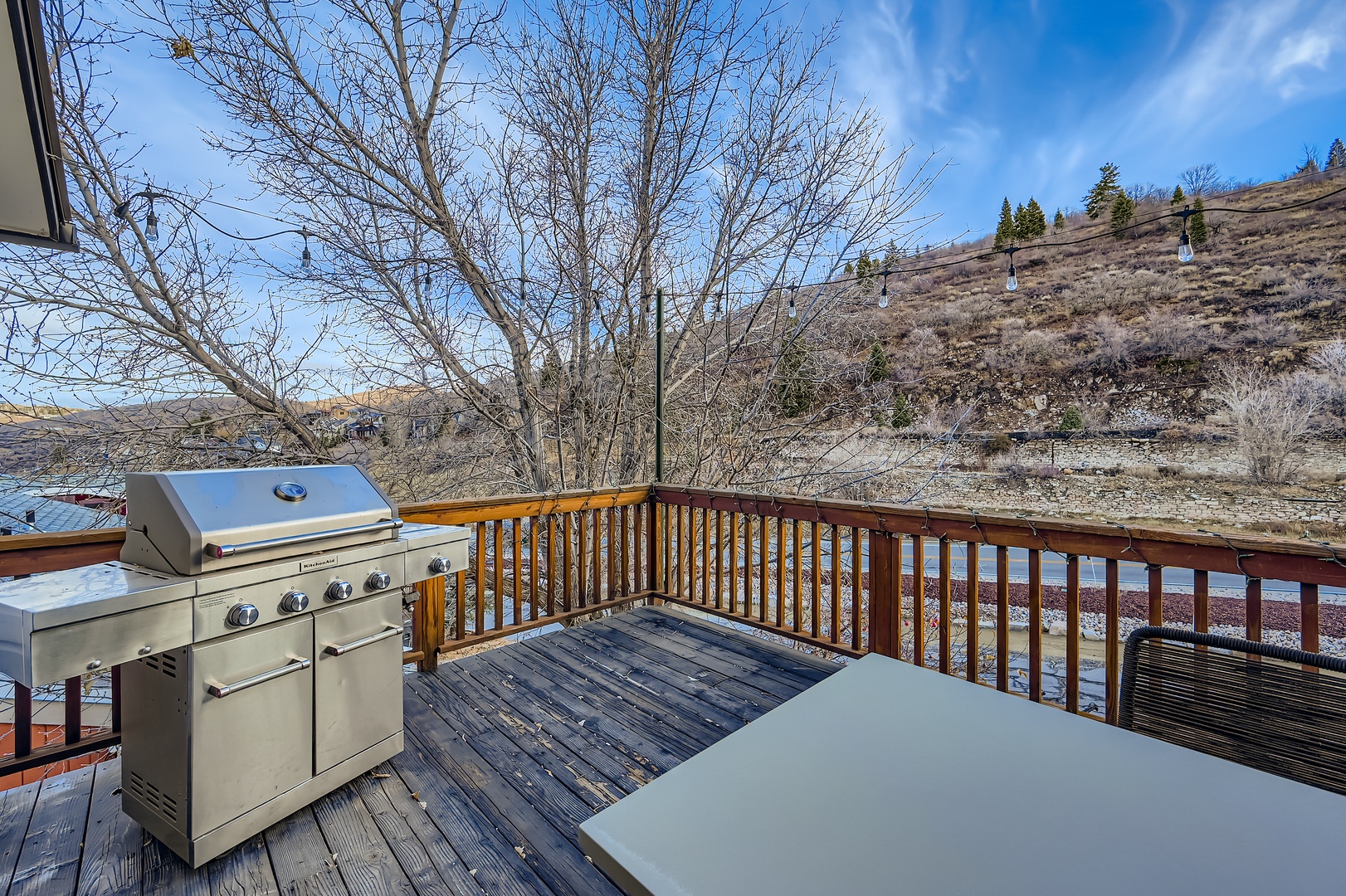 Picture yourself grilling fresh burgers on the deck while scenic hillsides frame your outdoor feast. This private patio invites relaxed dining with mountain views all around.
