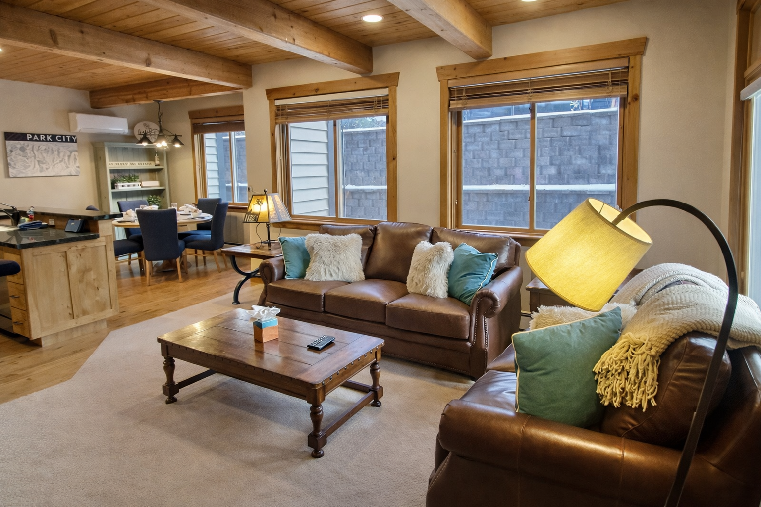 Relax in this cozy mountain living room, complete with warm wood beams and comfortable leather seating.