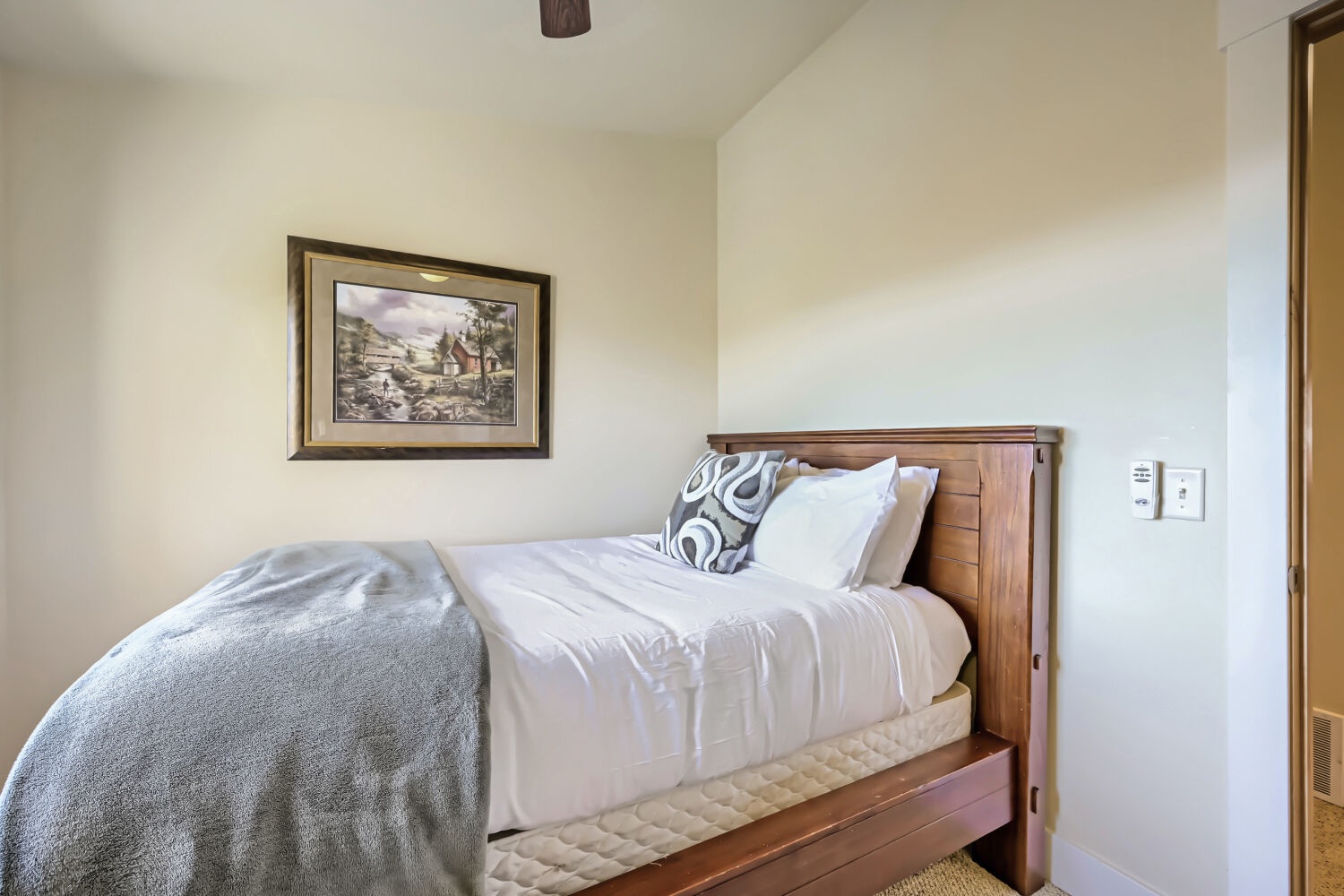 Slip into fresh linens and let your cares drift away in this cozy bedroom, where clean comfort meets simple, restful charm.