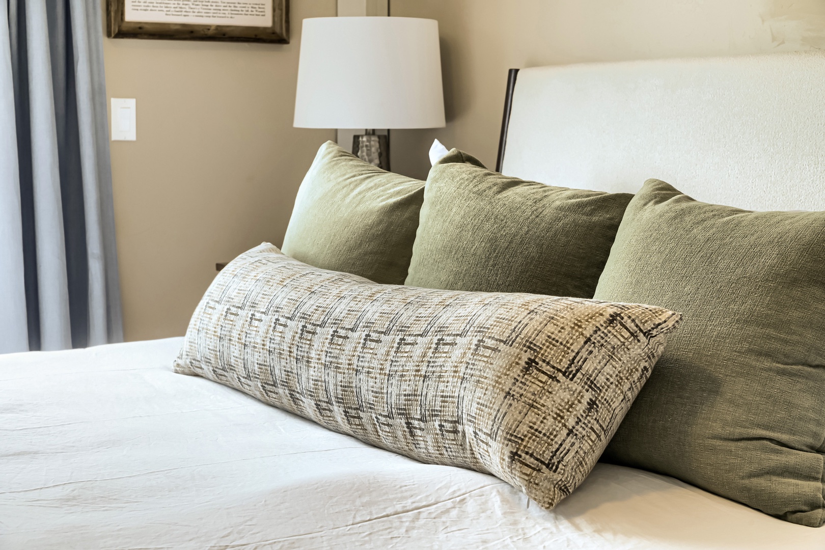 Sink into plush pillows and soft linens—your peaceful retreat awaits, with warm lighting and calming earth tones creating the perfect atmosphere for rest.