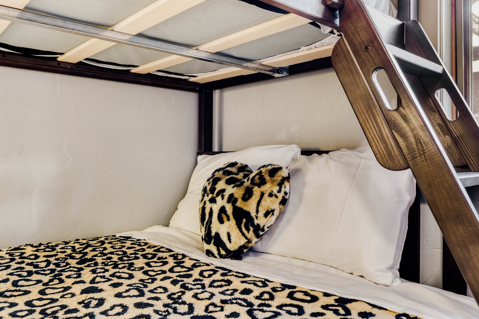 Rest comfortably in your cozy sleeping nook with bold leopard print bedding and thoughtful space-saving design.