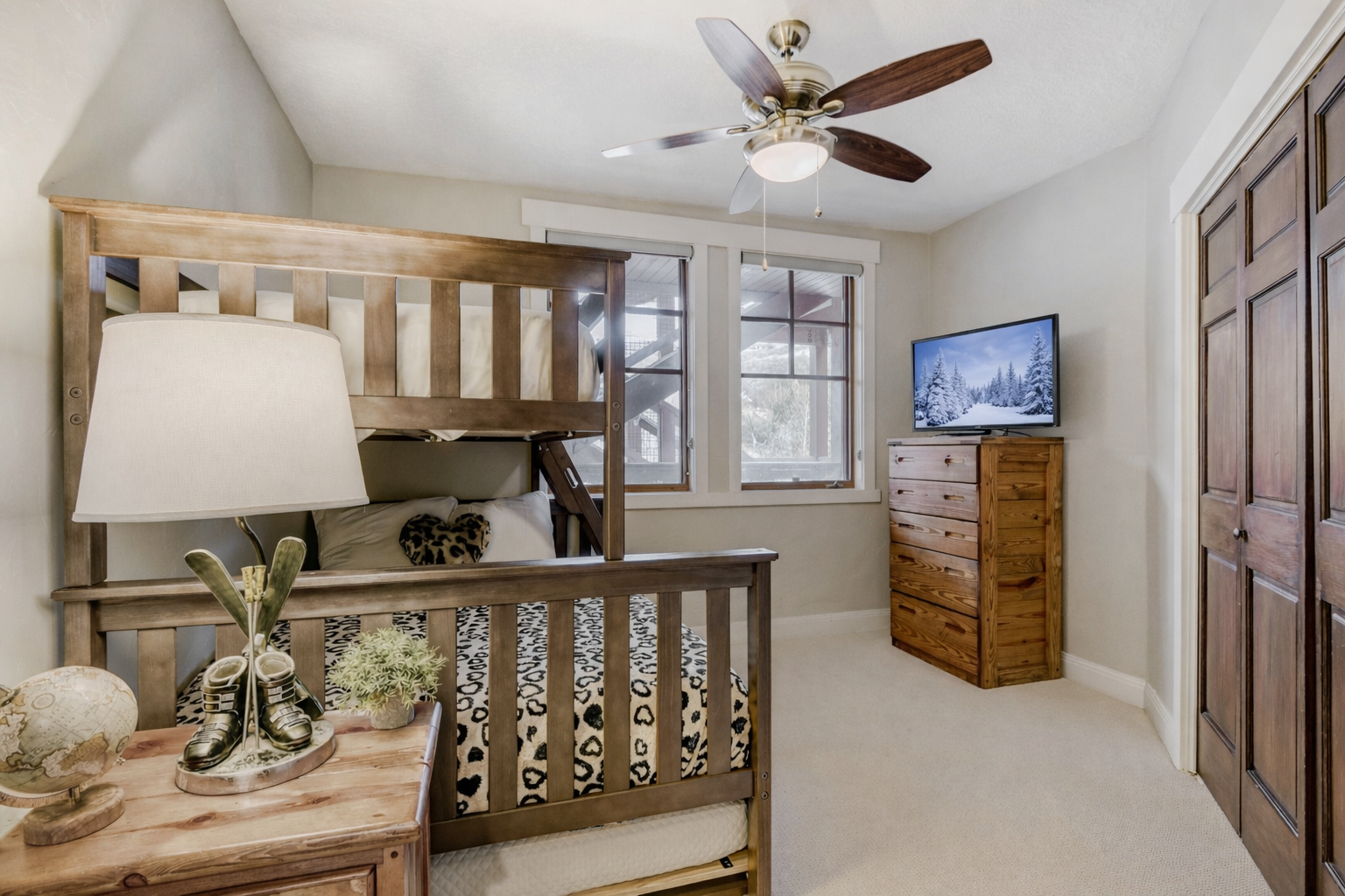 Your kids will love this cozy bunk room with rustic wood furniture and mountain views from the window.
