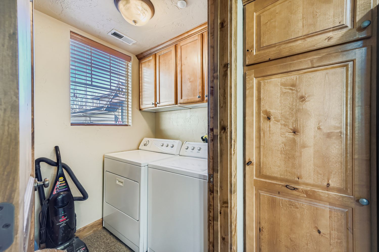 Your private laundry room features full-size washer and dryer with ample cabinet storage, making extended stays effortless and convenient.
